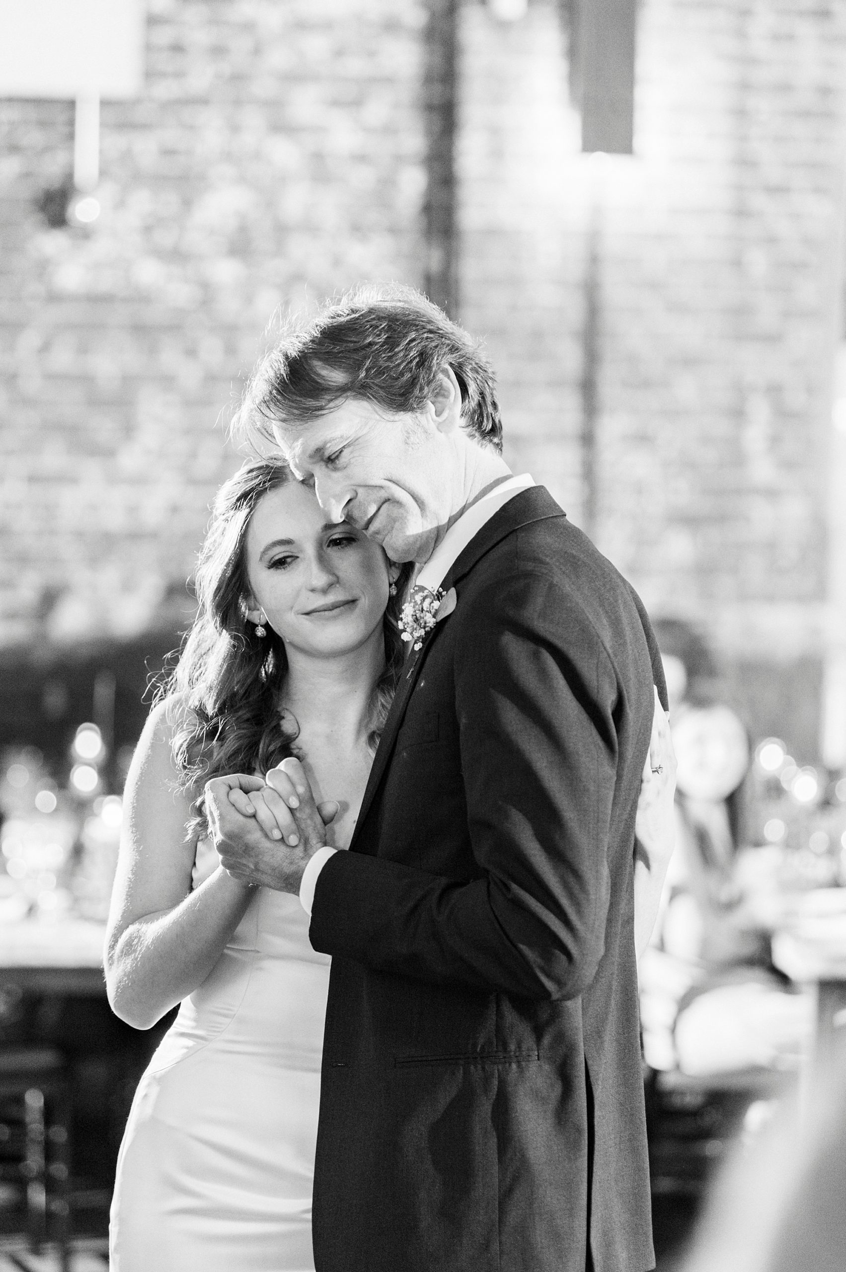 bride hugs father during Greensboro NC wedding reception 