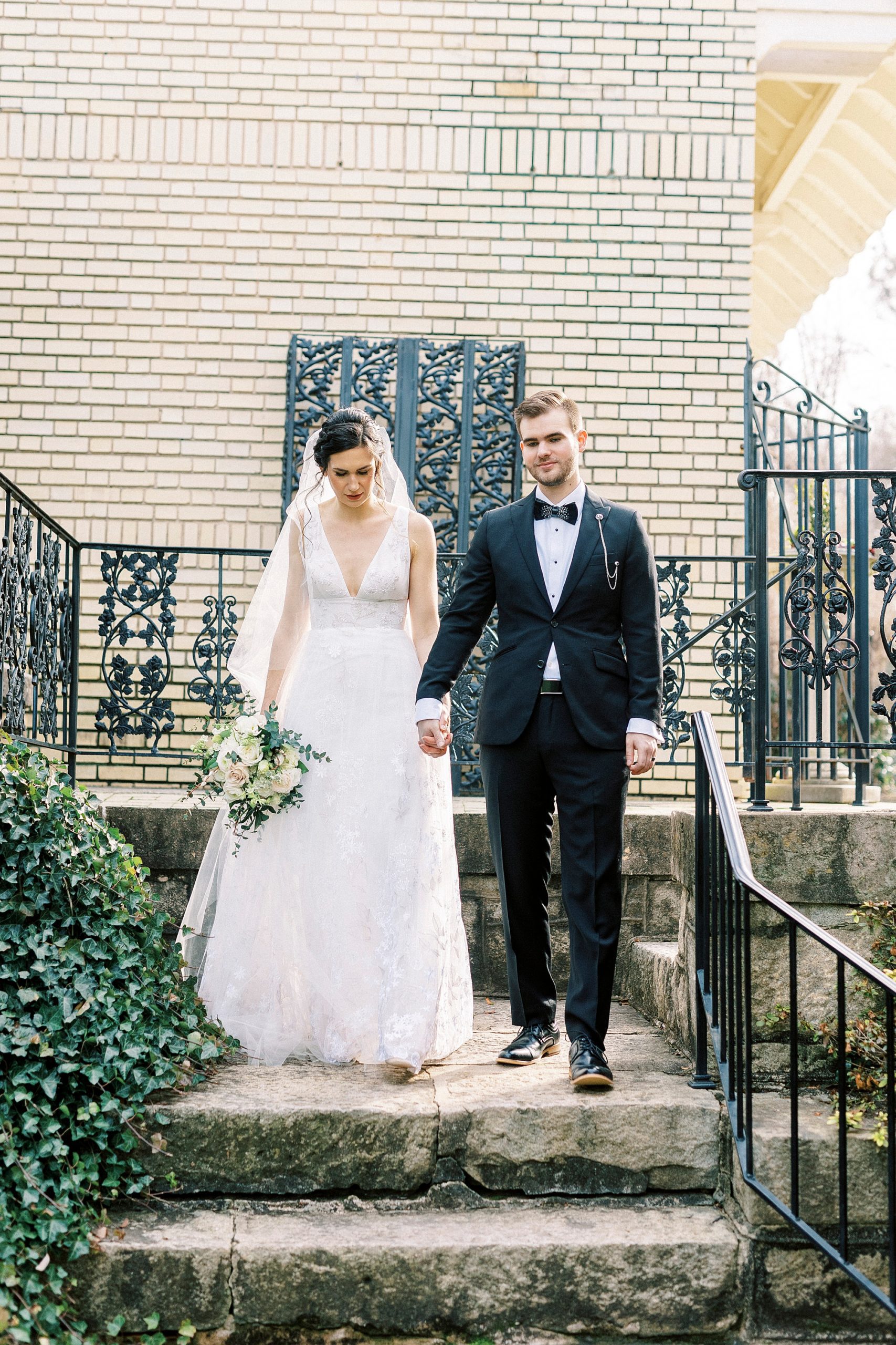 bride and groom walk down stone steps at Separk Mansion