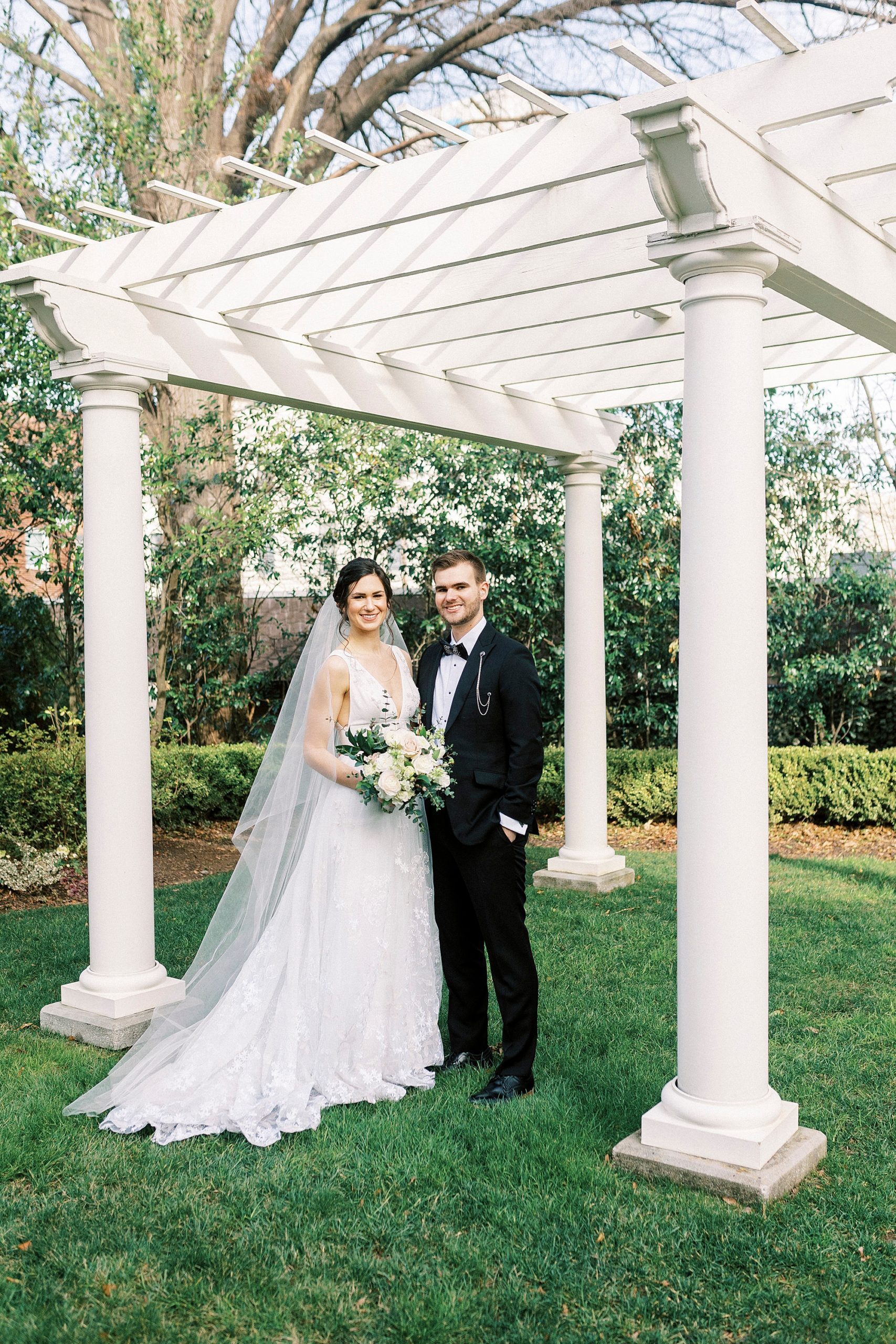 newlyweds hug under gazebo at Separk Mansion