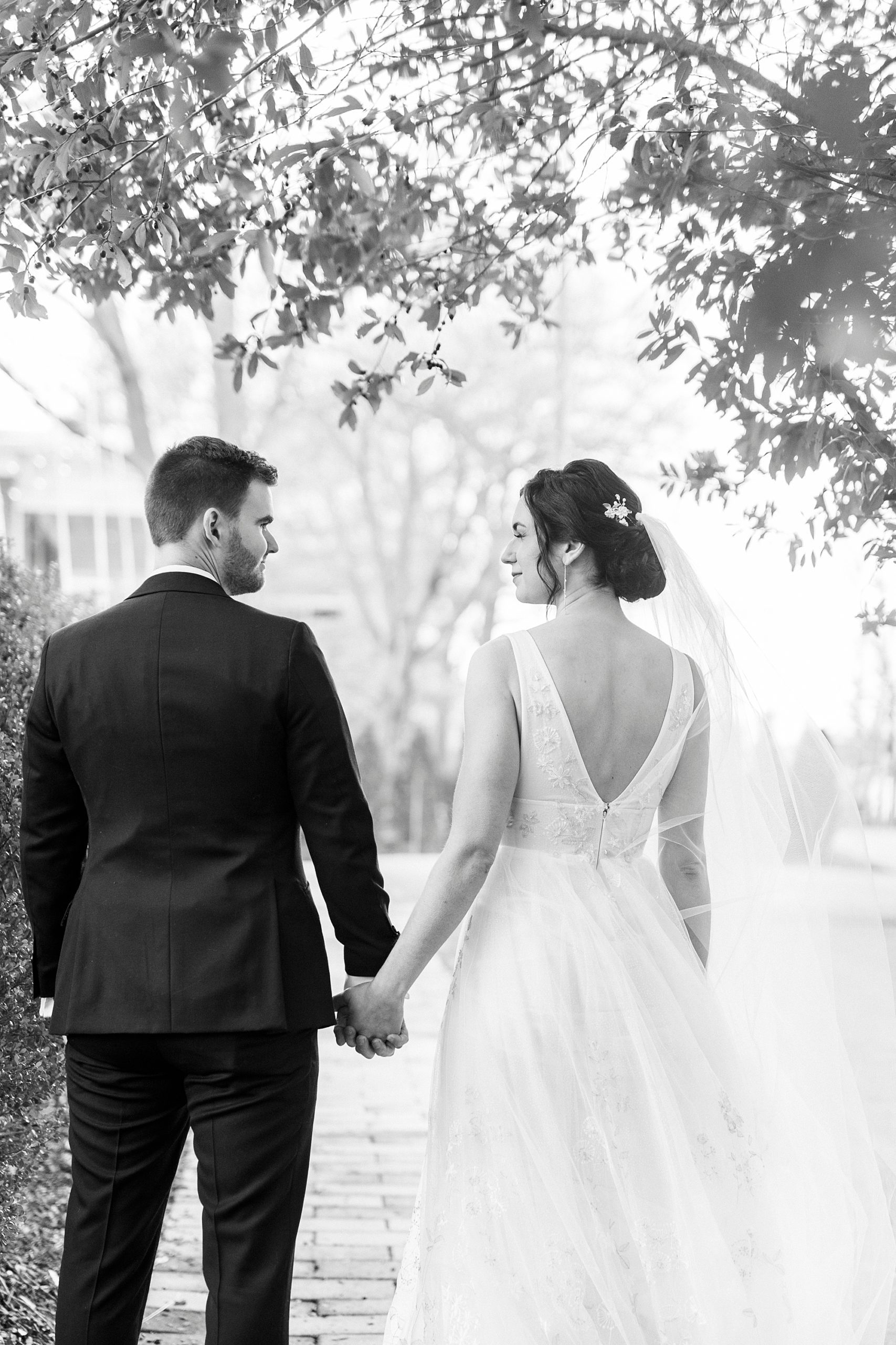 bride and groom hold hands walking through gardens at Separk Mansion