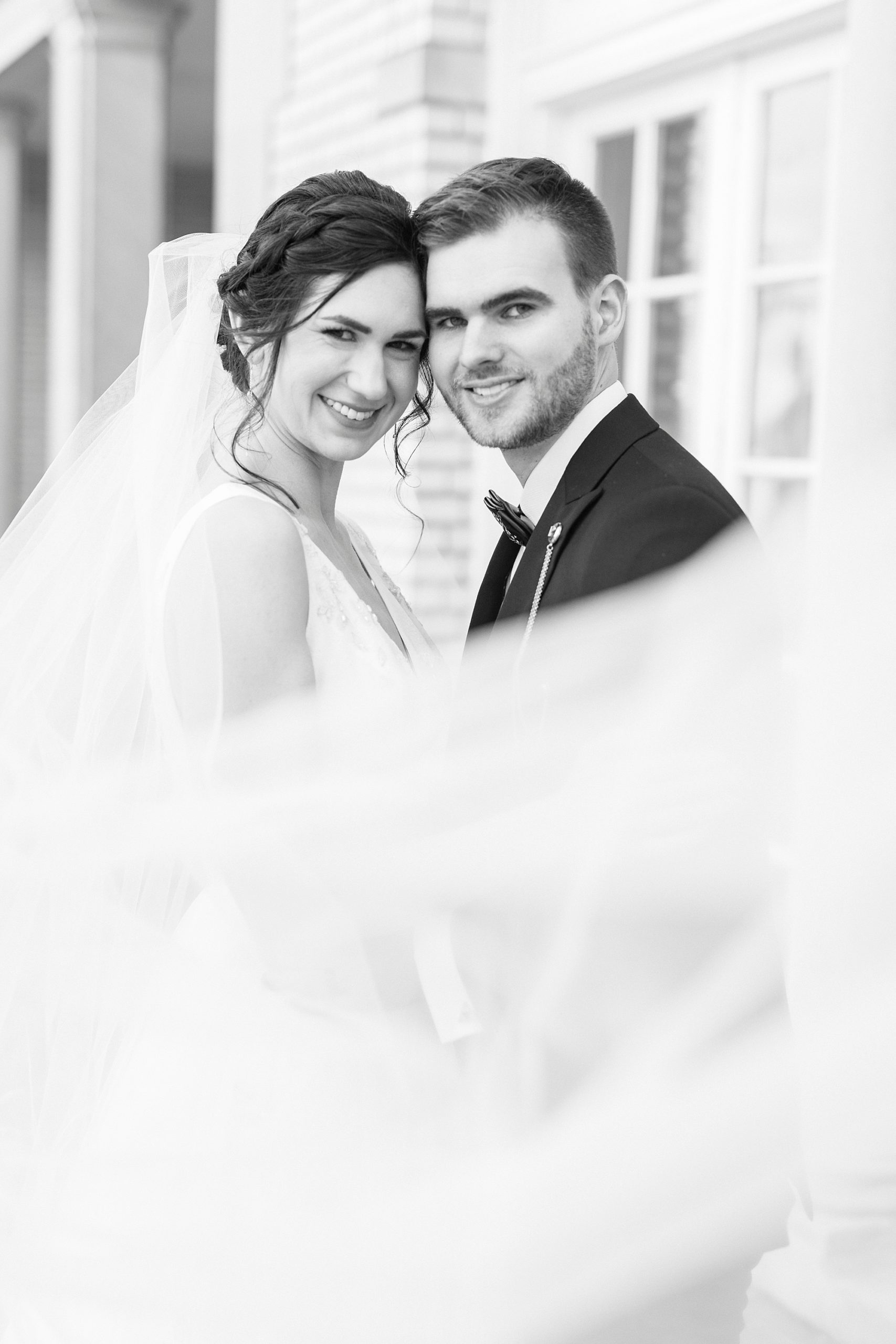 bride and groom hug with veil around them at Separk Mansion