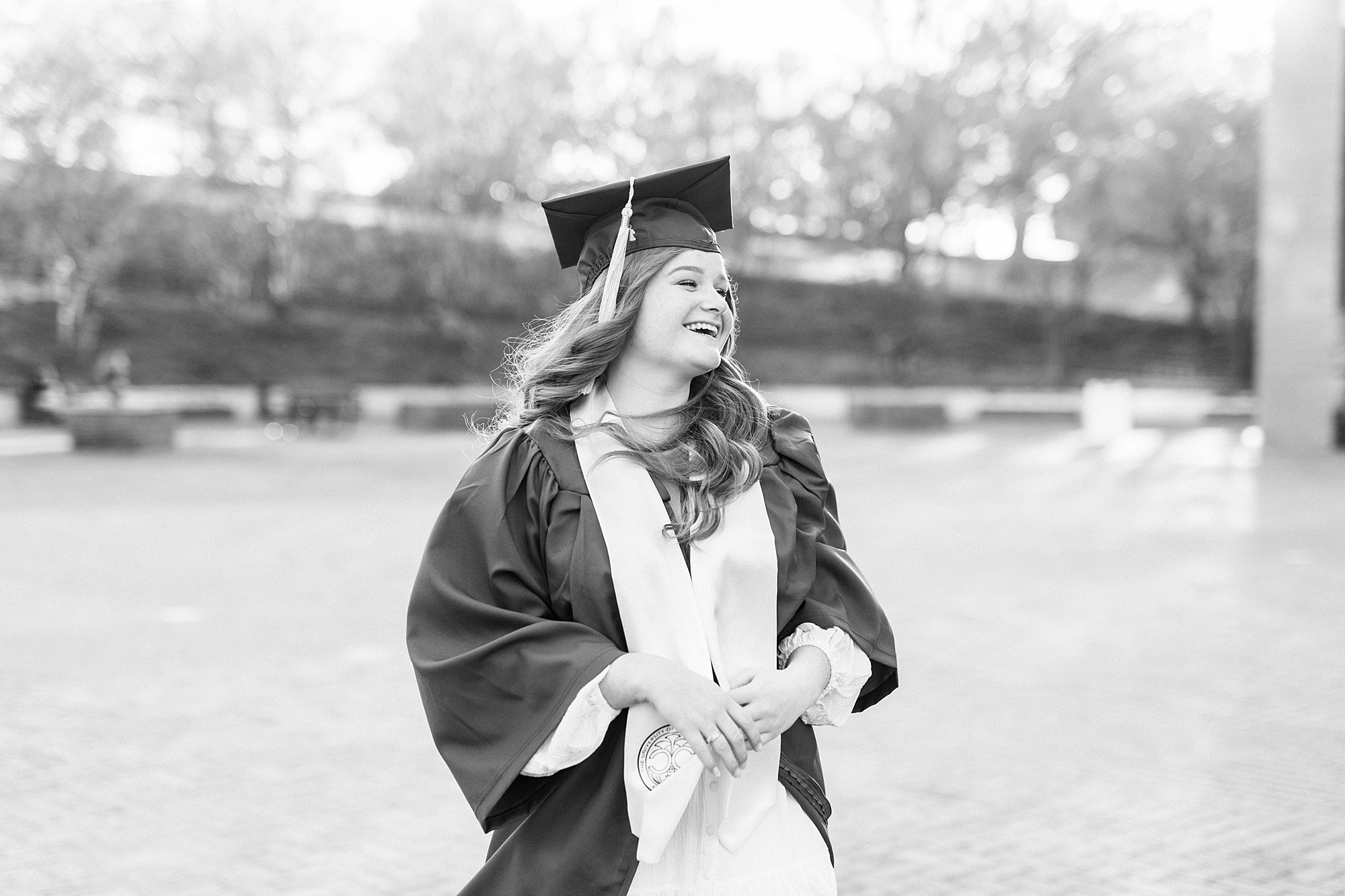 woman laughs during senior portraits at UNC Charlotte