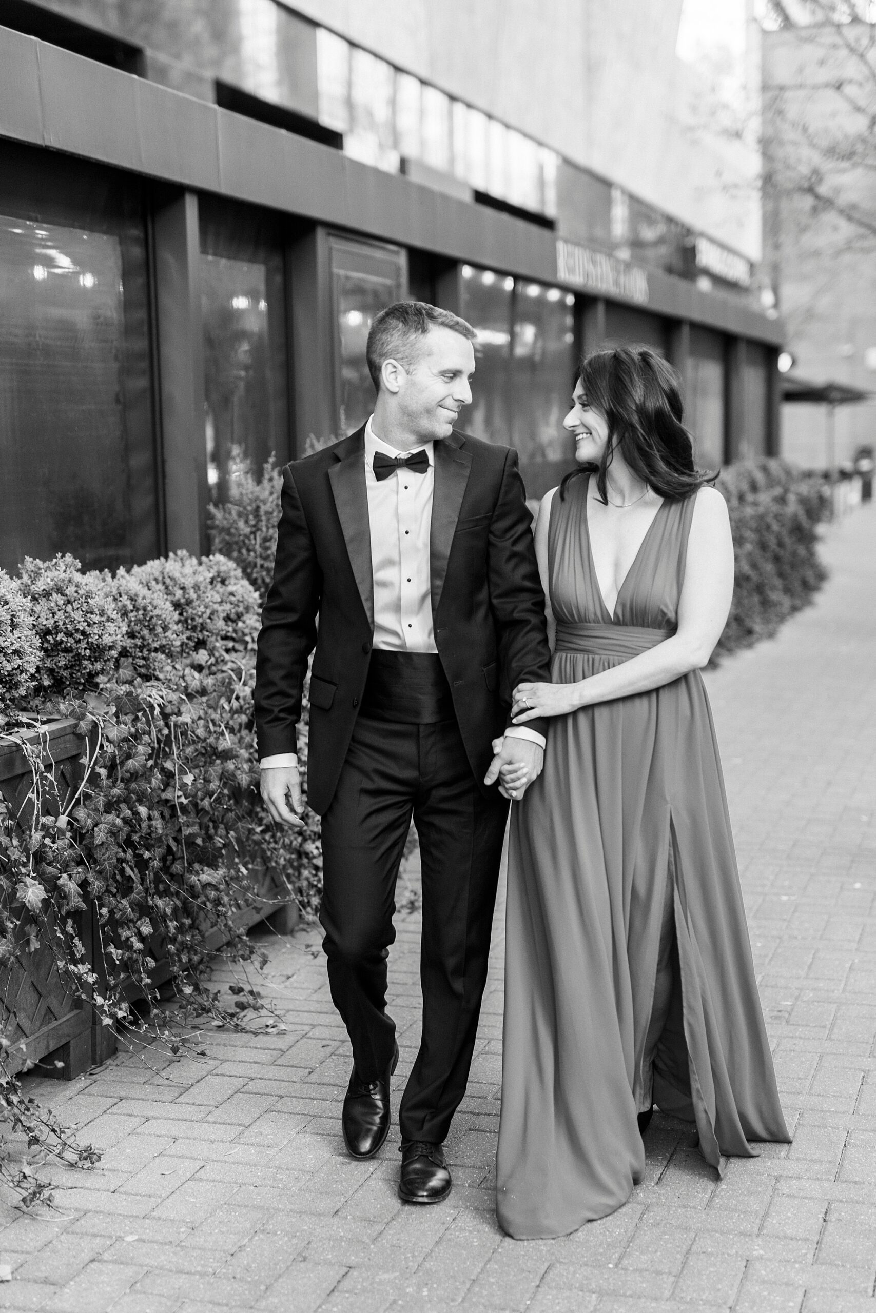 couple walks down street in Uptown Charlotte