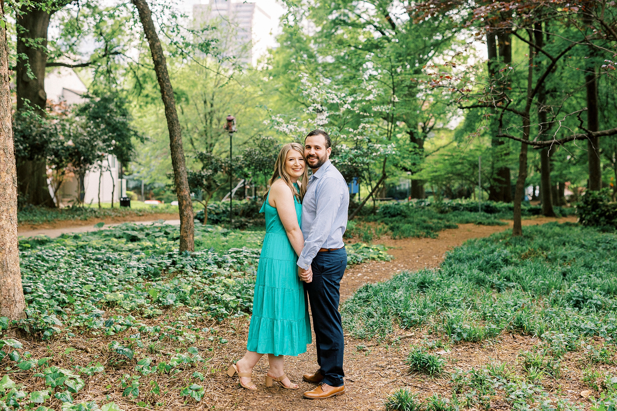 bride and groom hold hands in garden at Fourth Ward Park