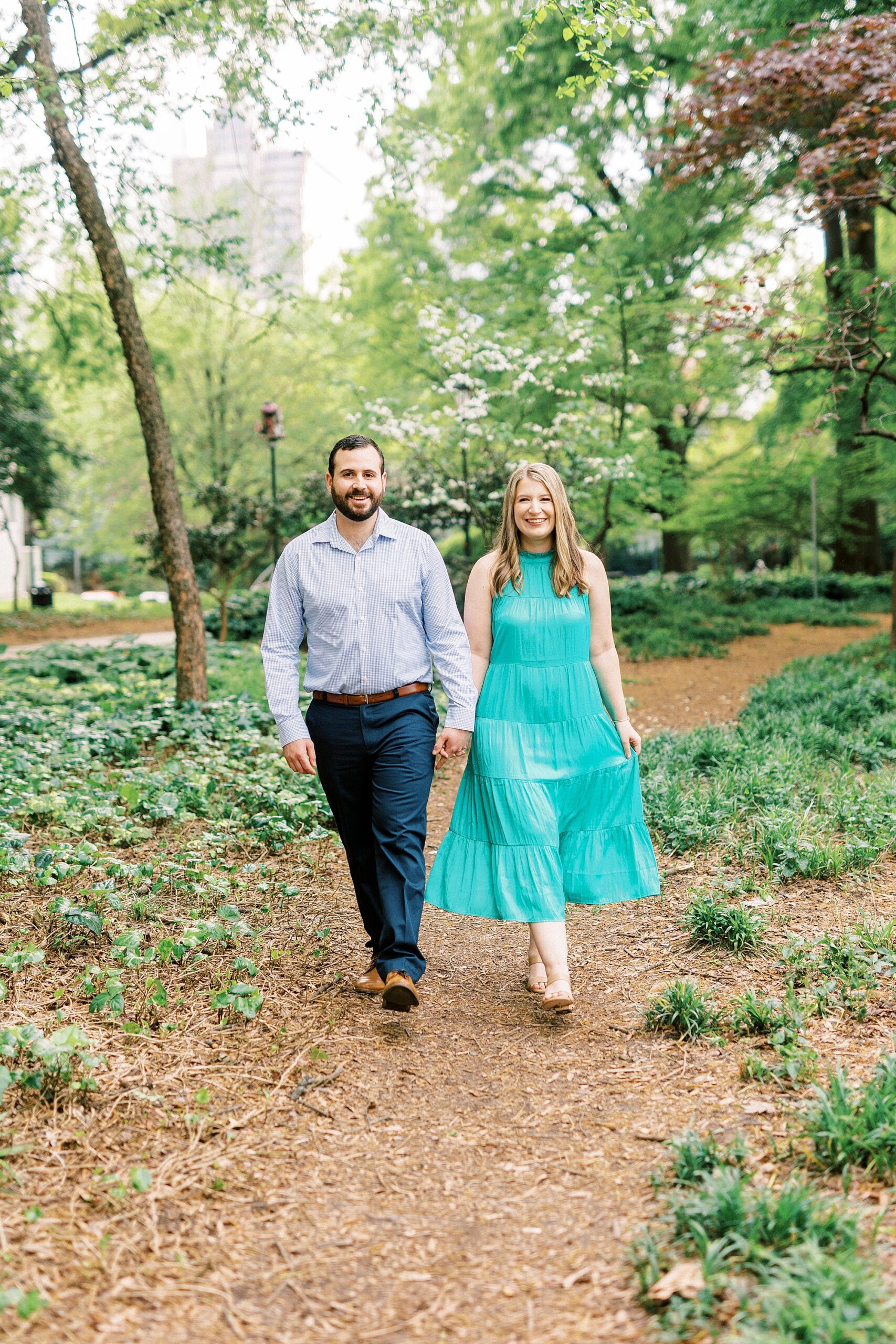bride and groom hold hands during Fourth Ward Park engagement session