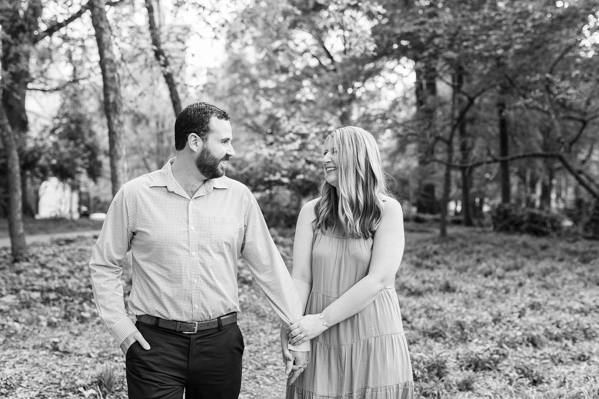 bride and groom hold hands dung summer engagement session at Fourth Ward Park
