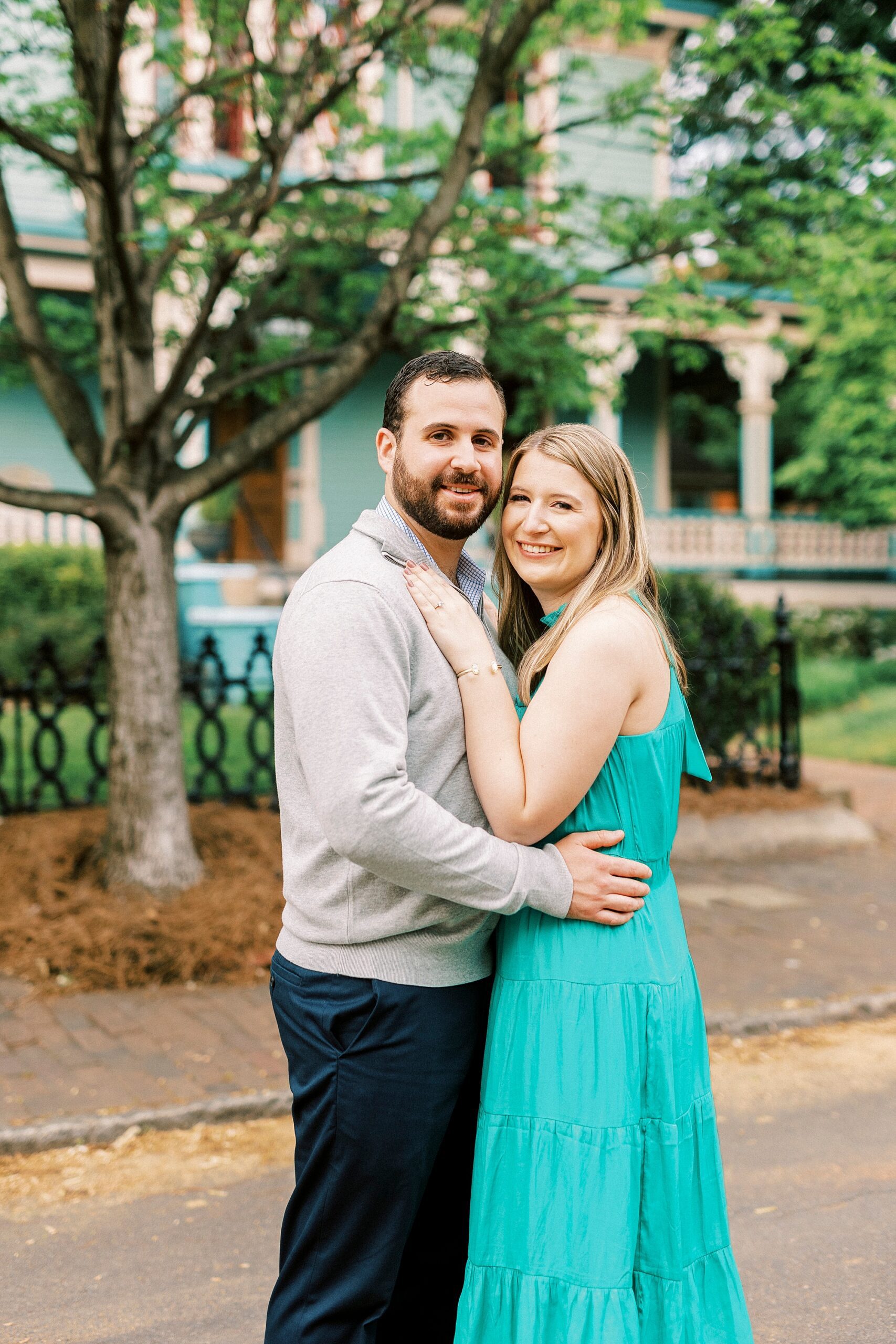 engaged couple hugs outside homes in Charlotte NC