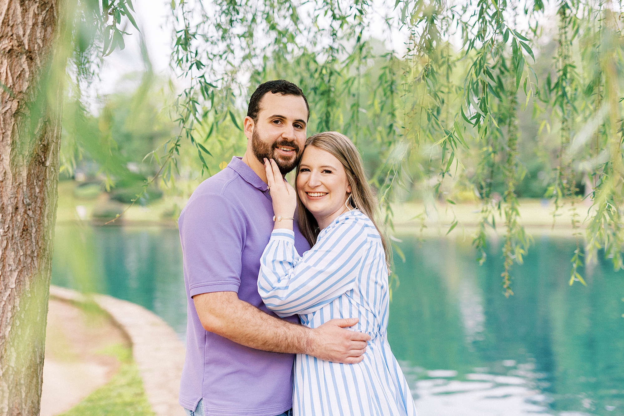 bride and groom hug under weeping willow at Freedom Park