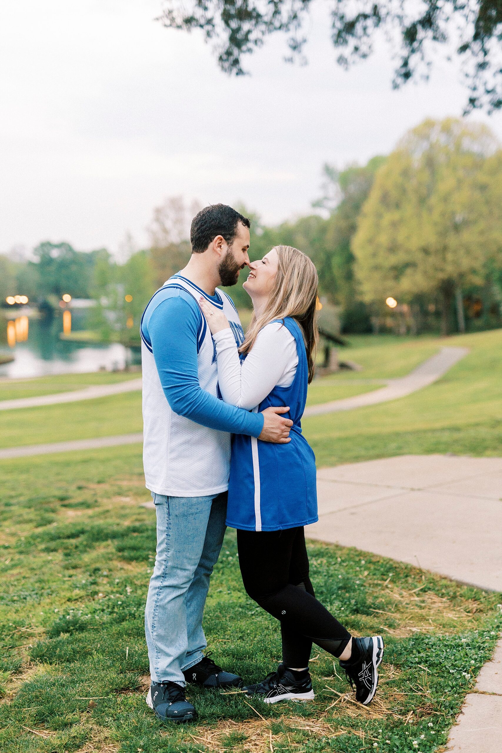 bride and groom hug in matching Kentucky jerseys in Freedom Park