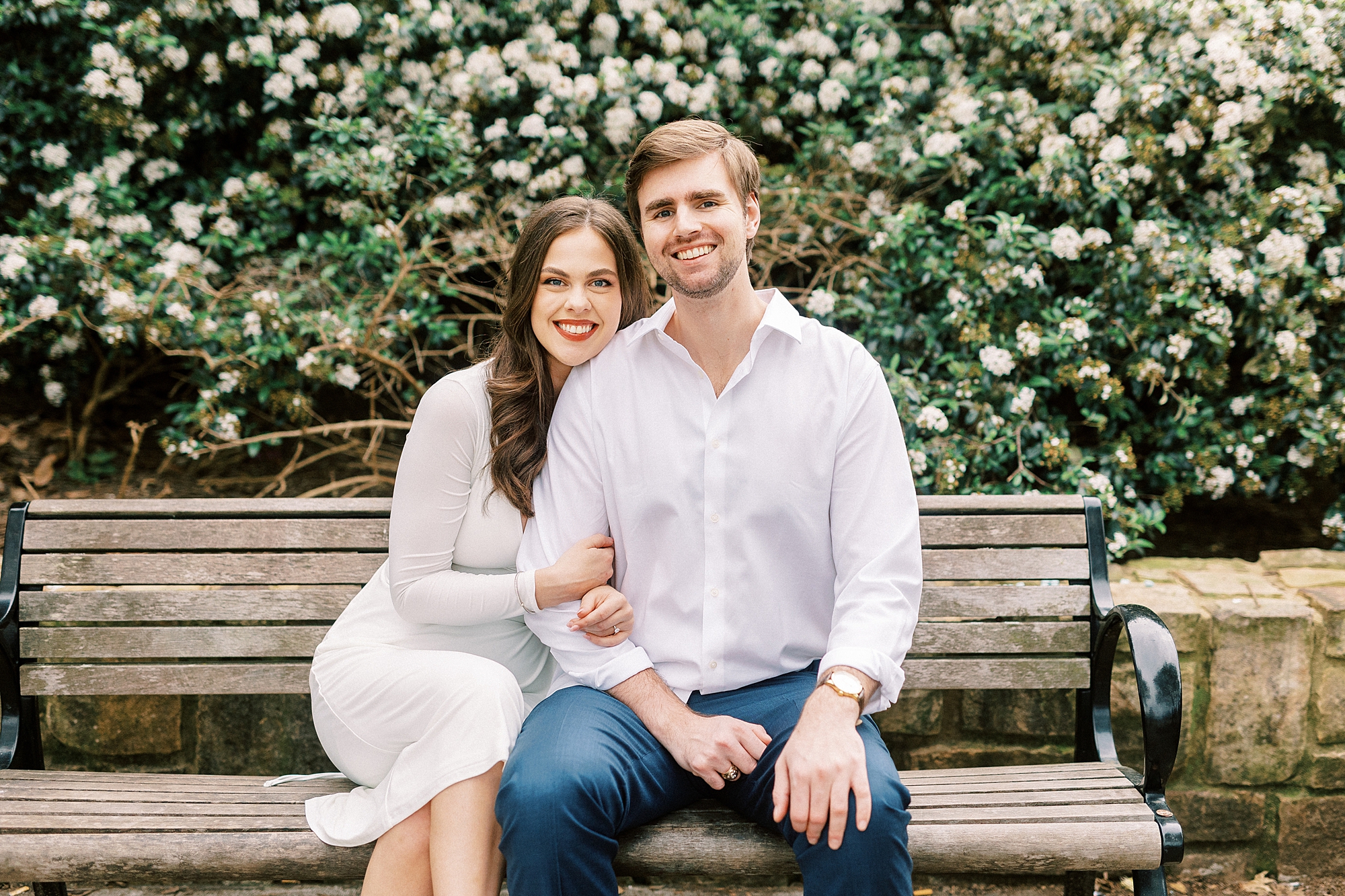 woman in white dress sits on park bench at Midtown Park