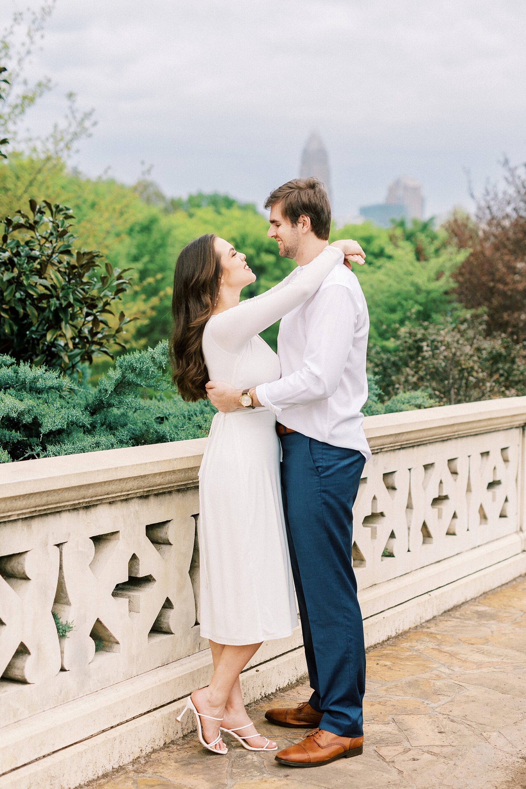 couple hugs on stone bridge in Midtown Park