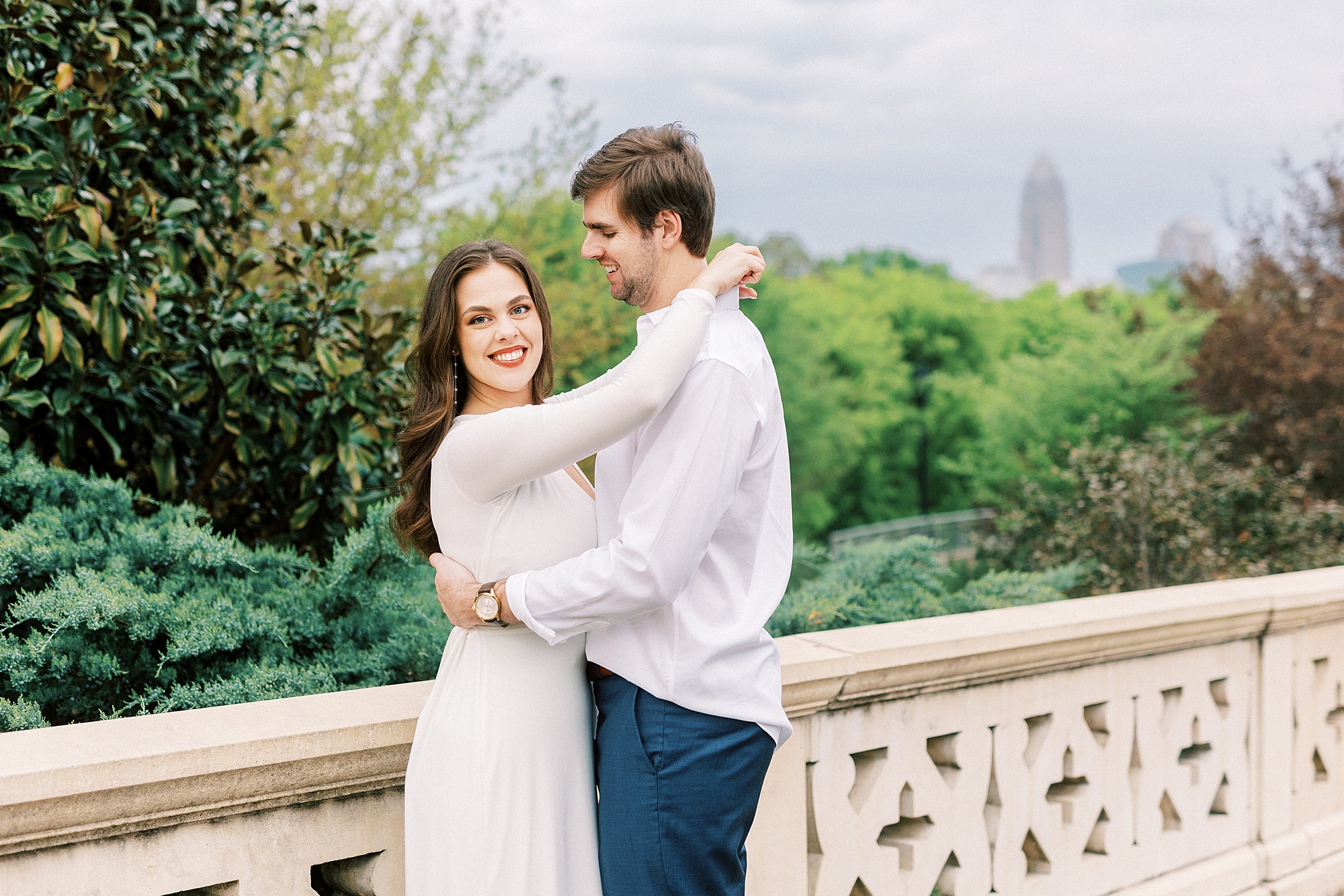 man smiles down at woman on bridge at Midtown Park