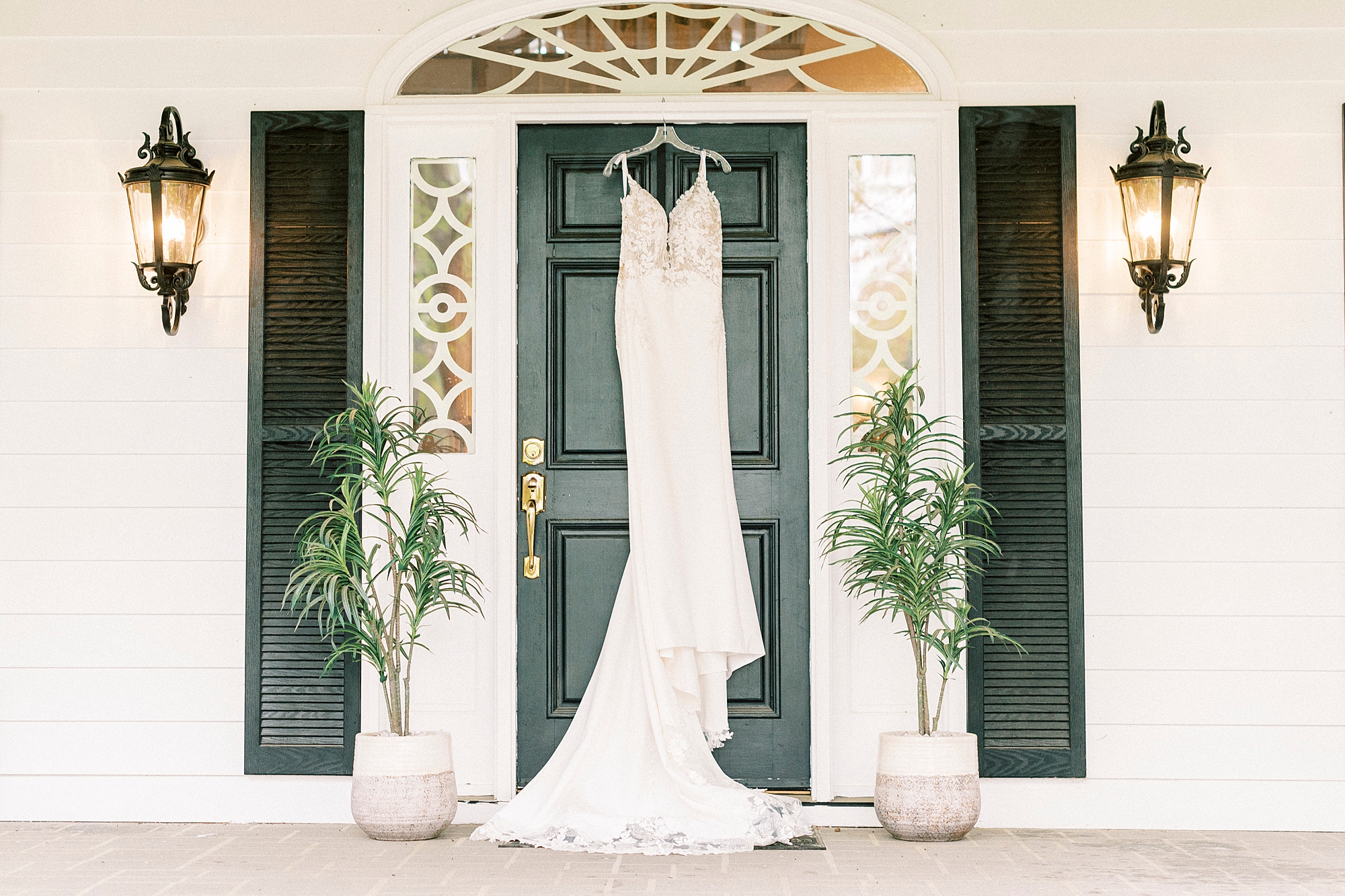 bride's dress hangs on green door at The Saratoga Springs