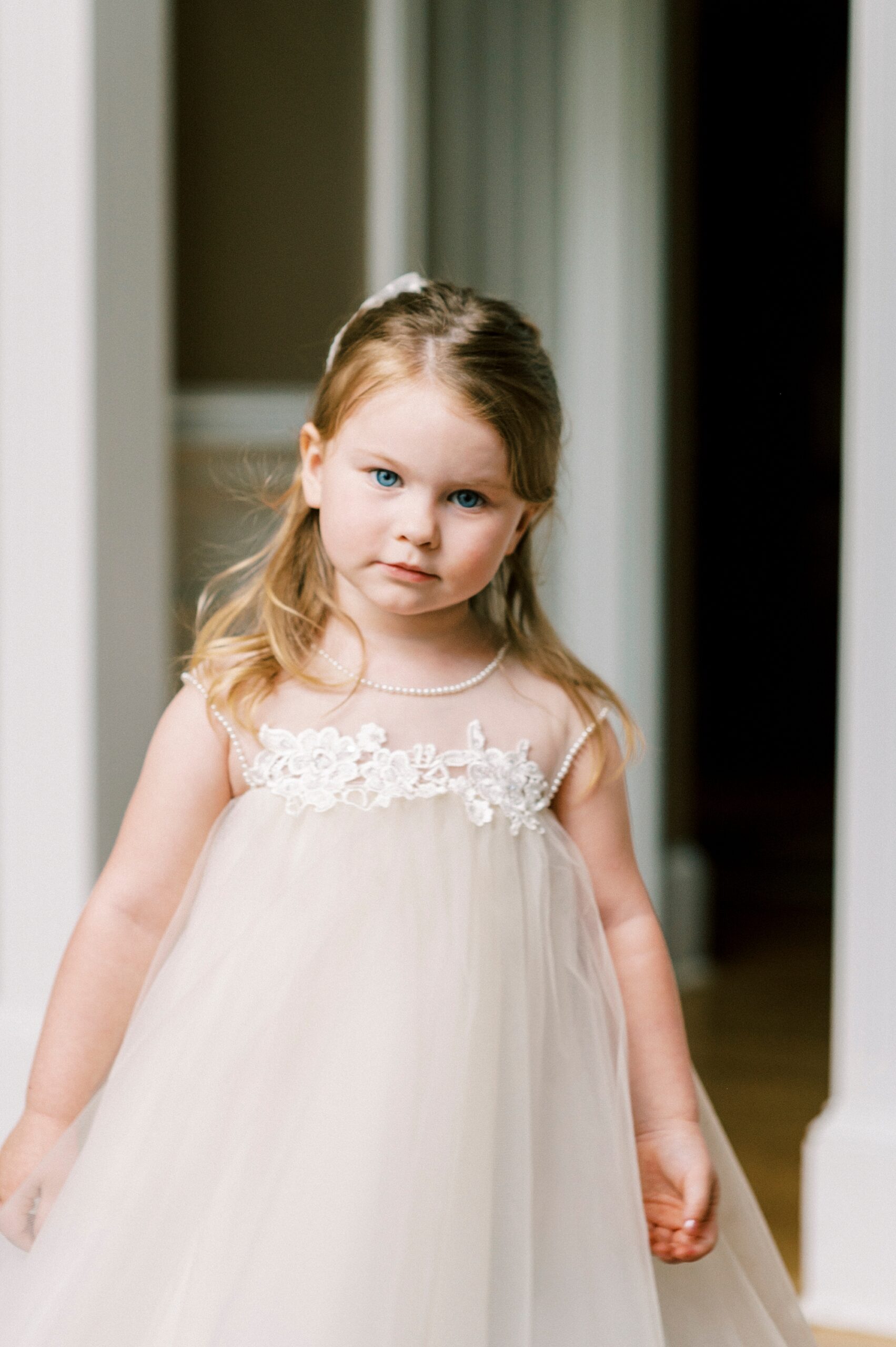 flower girl walks on porch at The Saratoga Springs 
