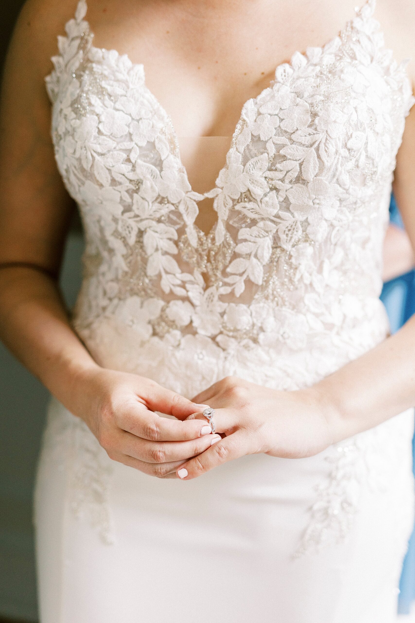 bride pushes wedding ring on hand at The Saratoga Springs