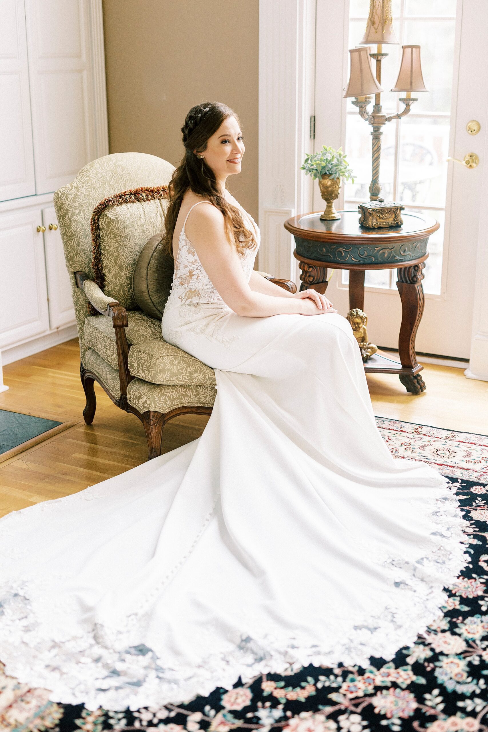 bride sits in gold chair with wedding dress around her at The Saratoga Springs