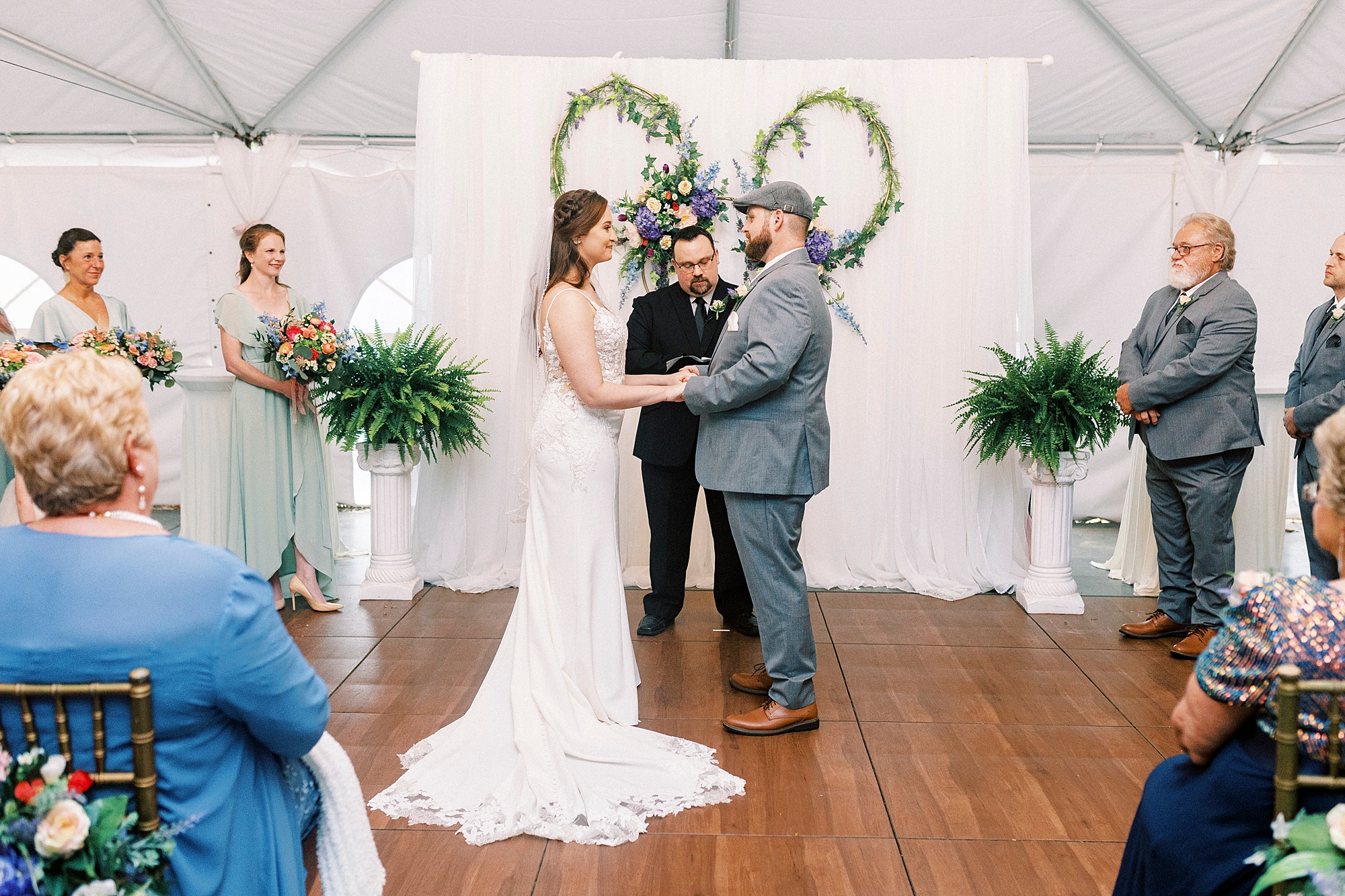 bride and groom hold hands during wedding ceremony at The Saratoga Springs