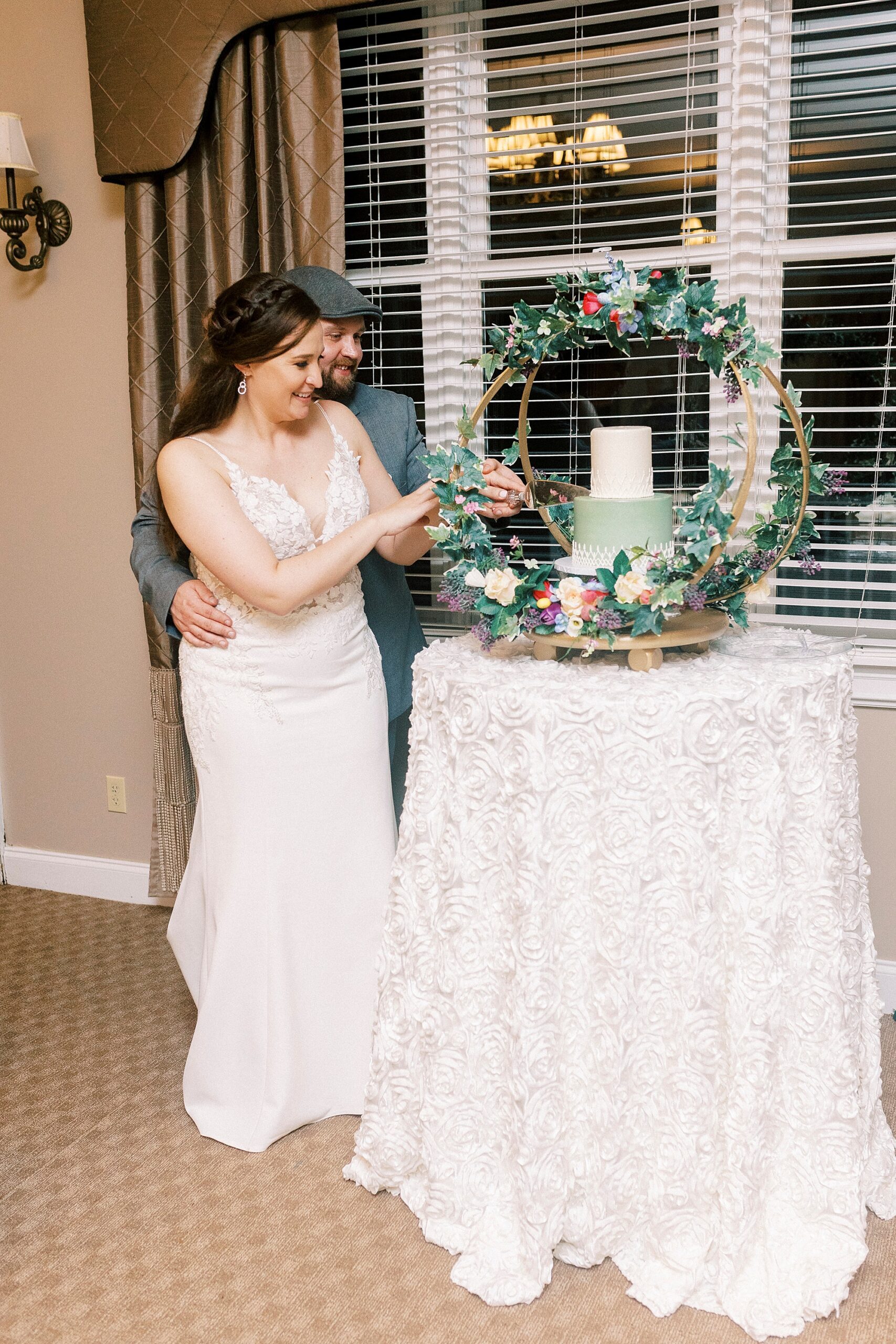 newlyweds cut wedding cake during Charlotte NC wedding reception 