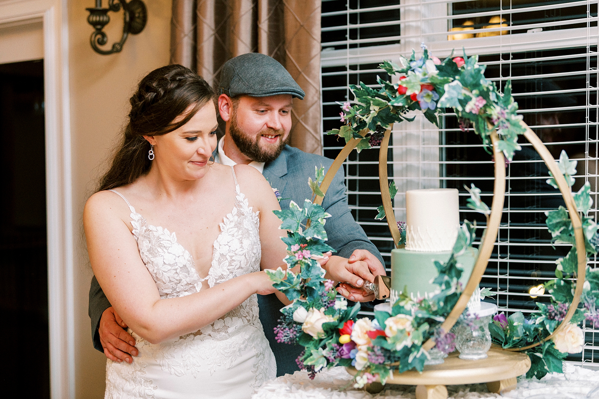 bride and groom cut wedding cake during Charlotte NC wedding reception 