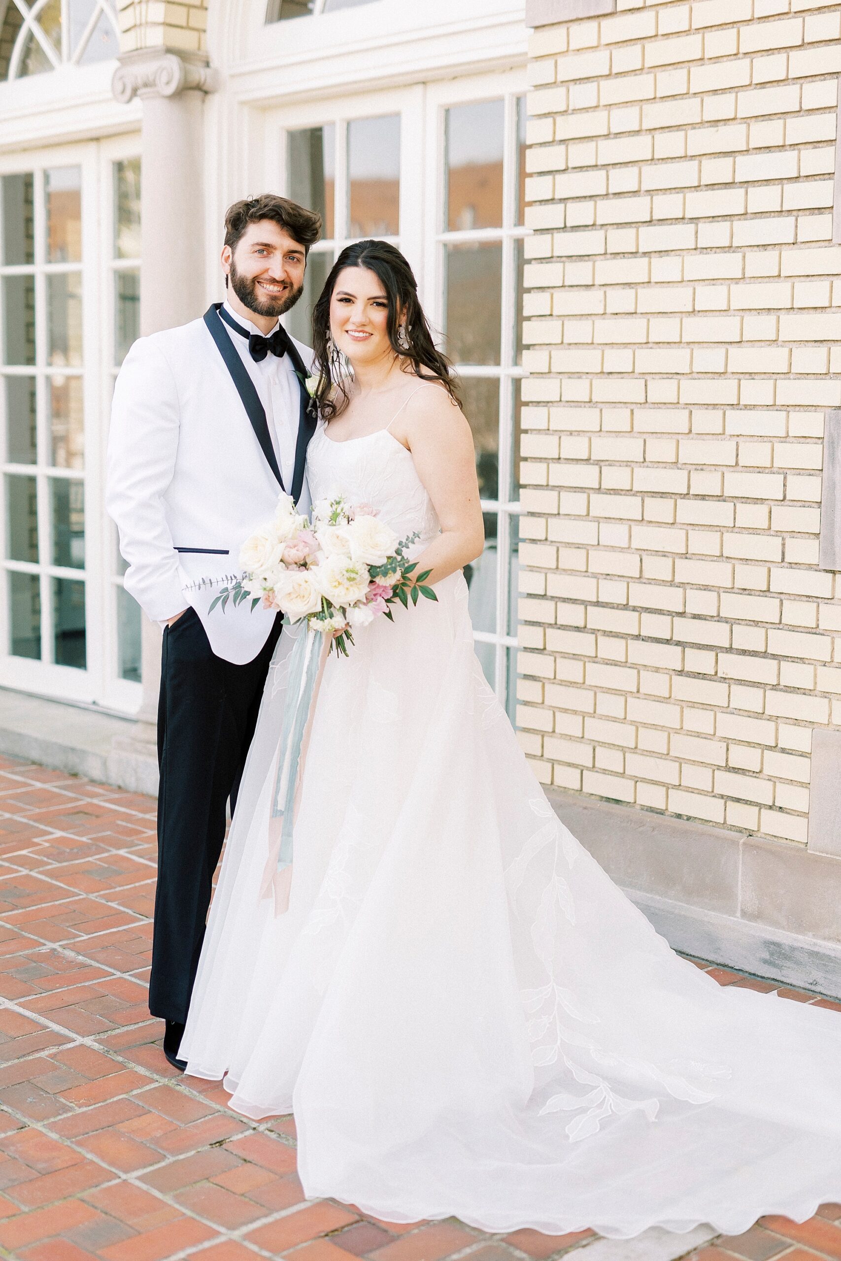 bride and groom hug on brick patio at Separk Mansion