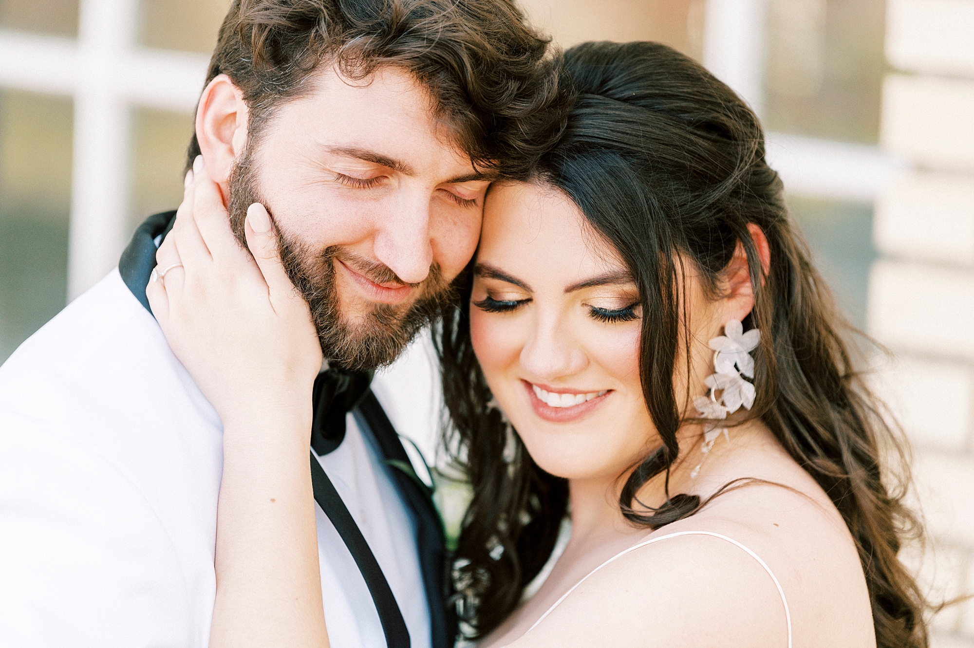 newlyweds lean heads together during portraits at Separk Mansion