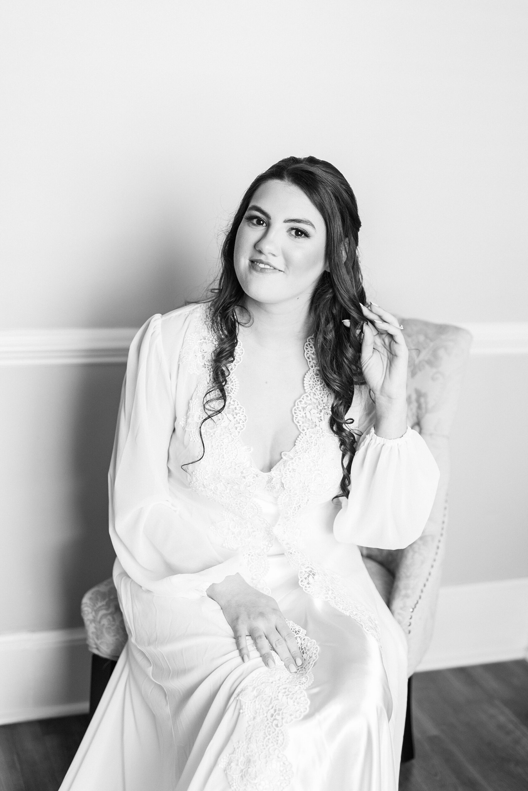 bride sits in robe moving hair off shoulder at Separk Mansion