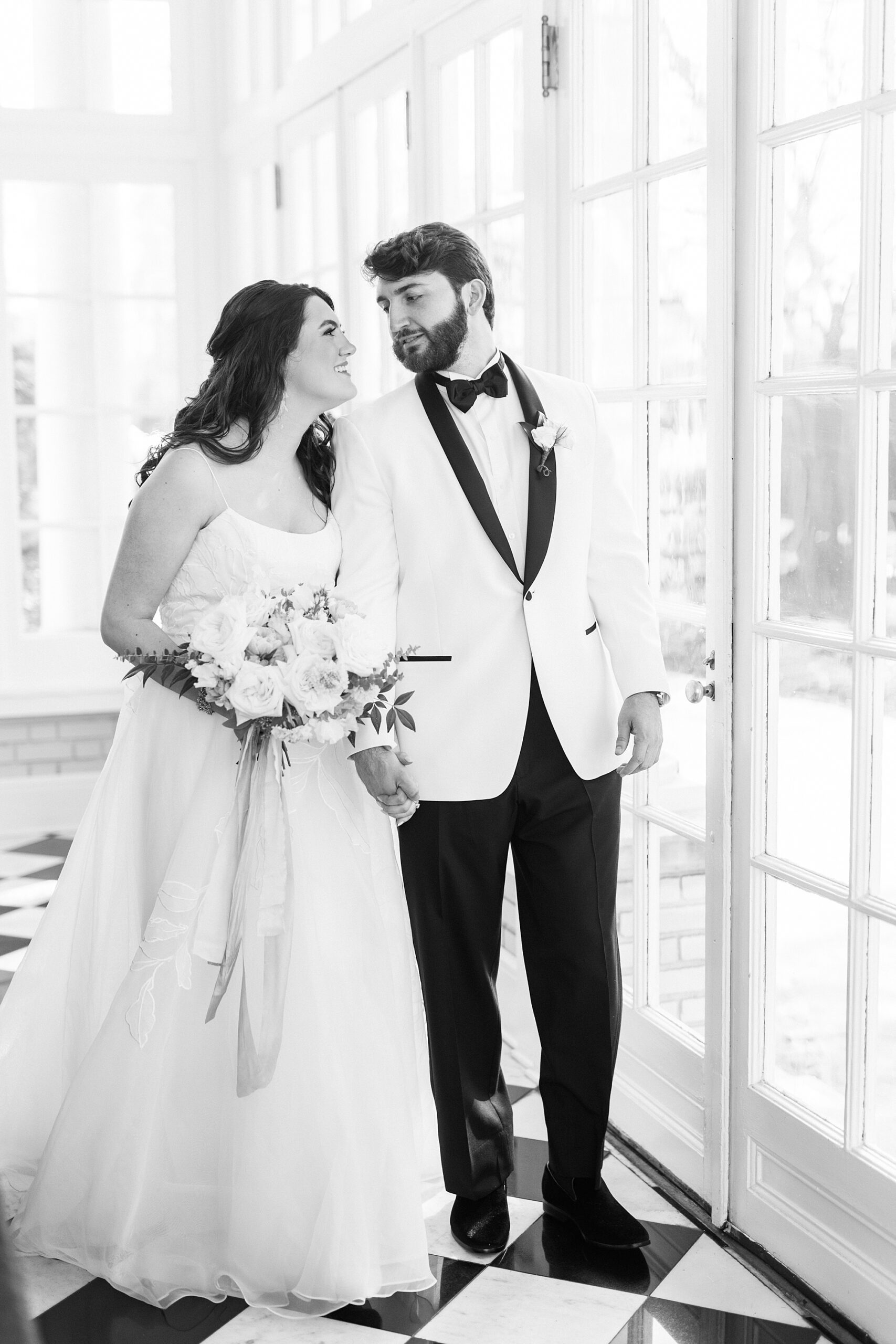 bride and groom hold hands looking at each other inside Separk Mansion