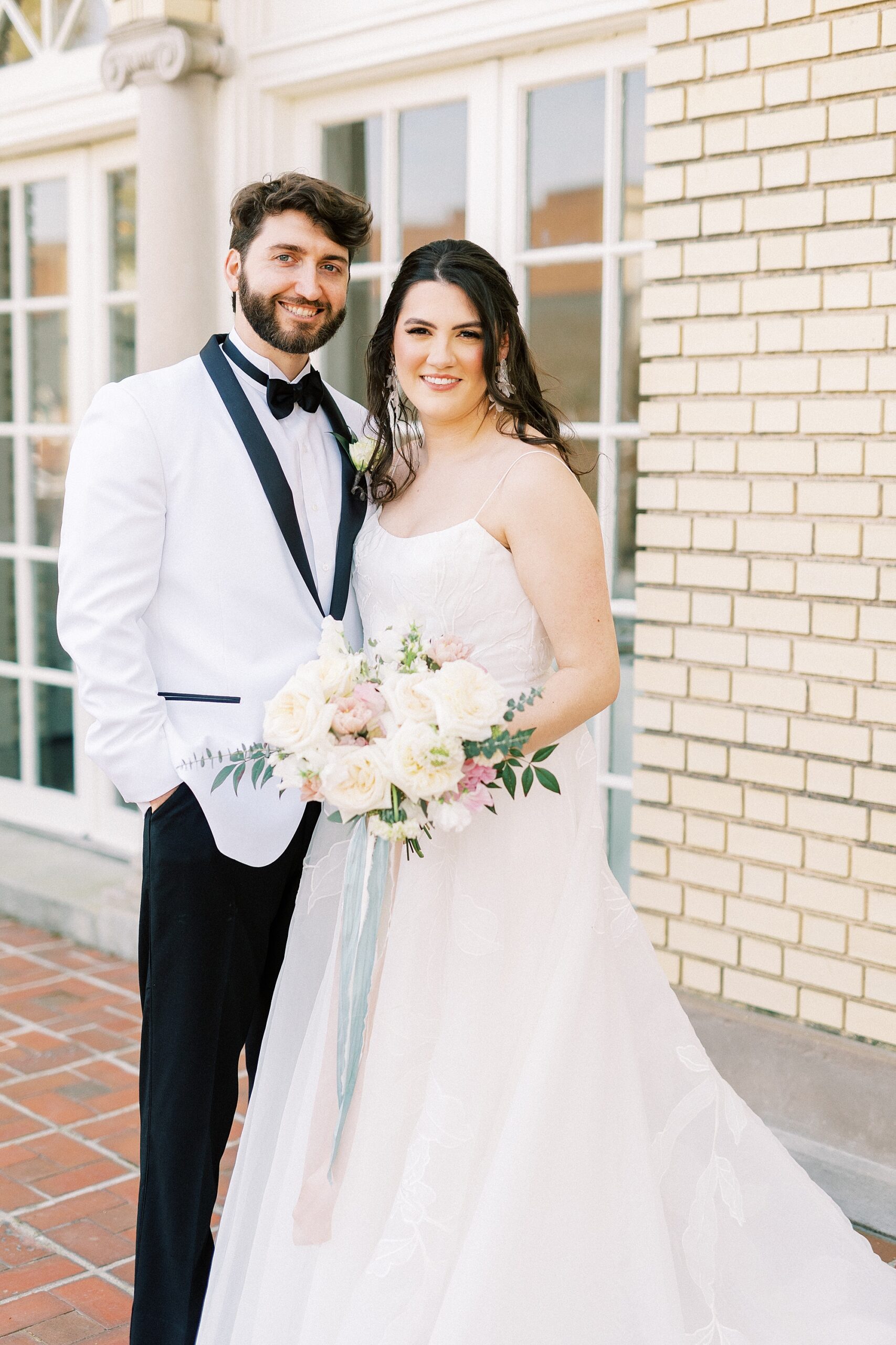 bride and groom stand hugging on patio at Separk Mansion
