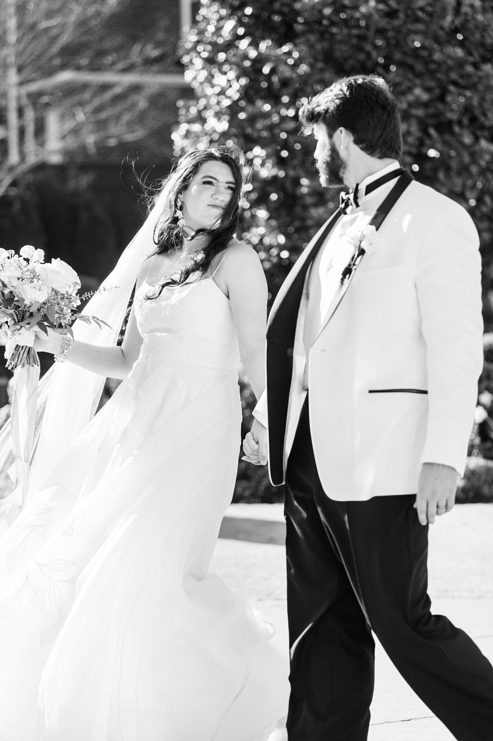 bride and groom hold hands walking through garden at Separk Mansion