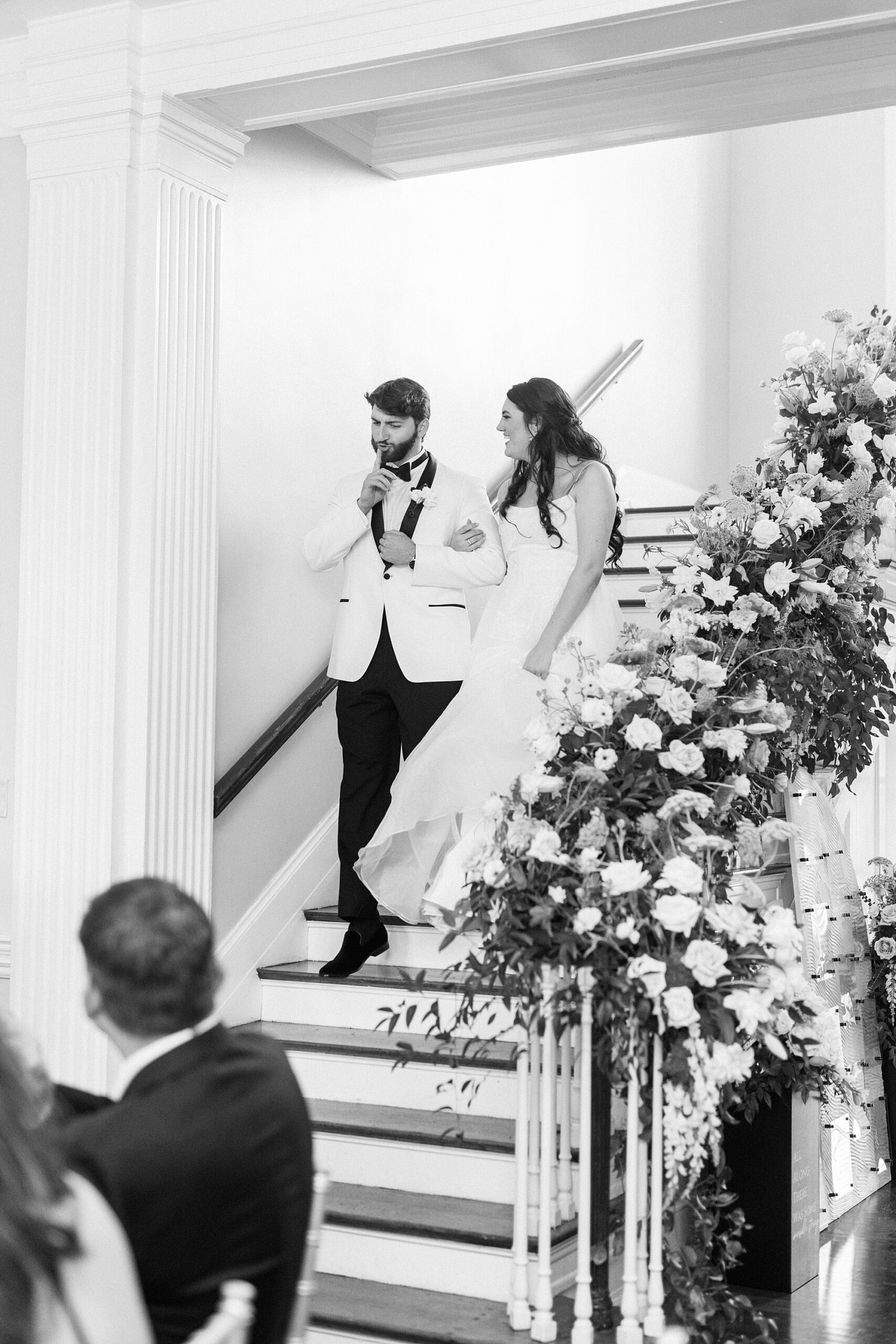 bride and groom hold hands walking down steps into reception nat Separk Mansion