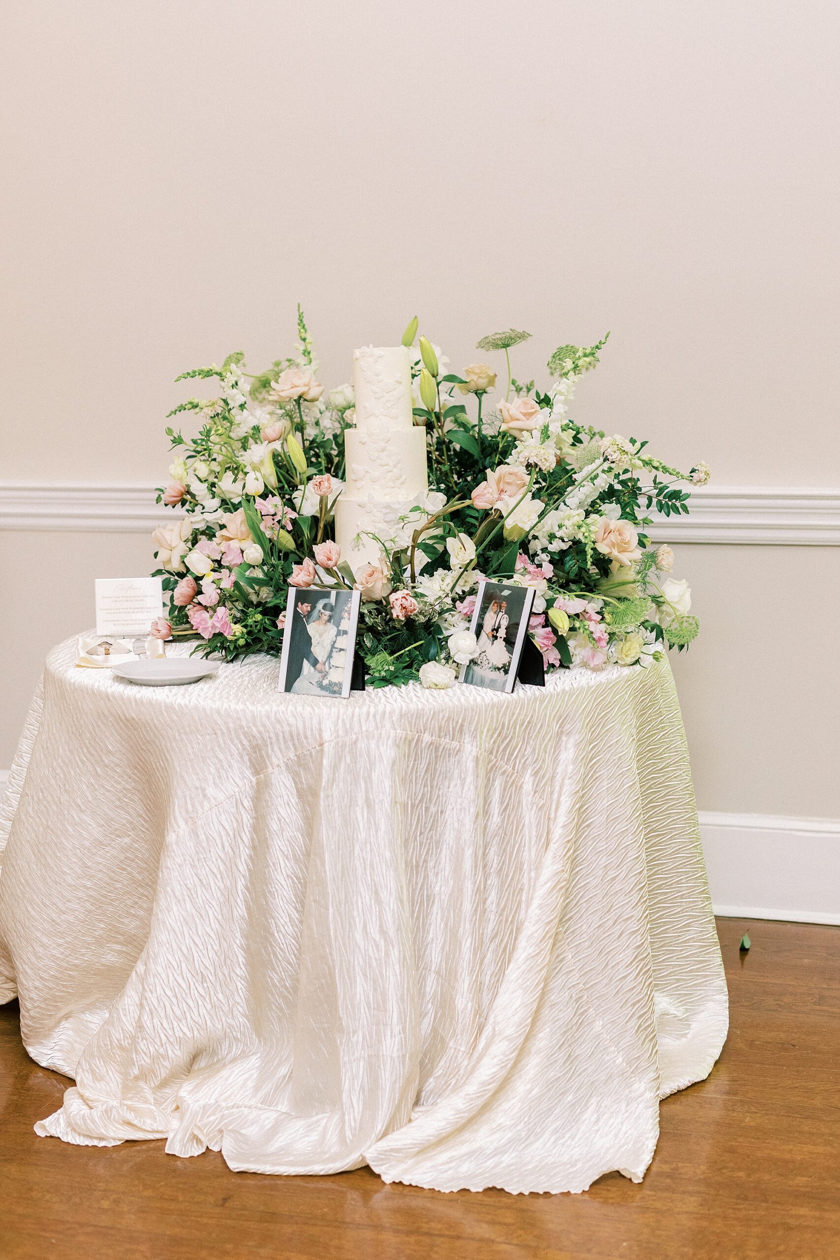 wedding cake display with green and pink flowers at Separk Mansion