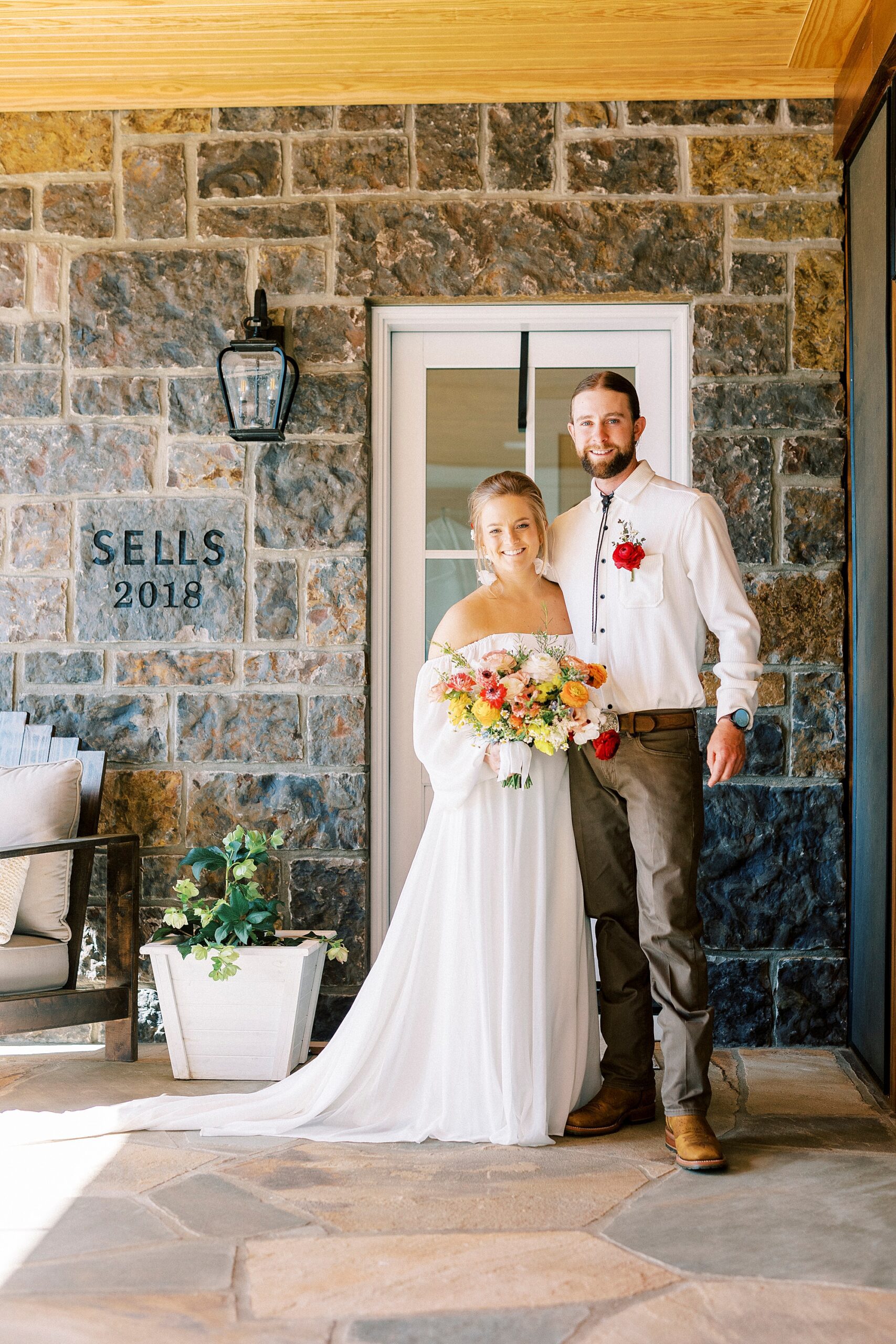 bride and groom hug on front porch of home in Richfield NC