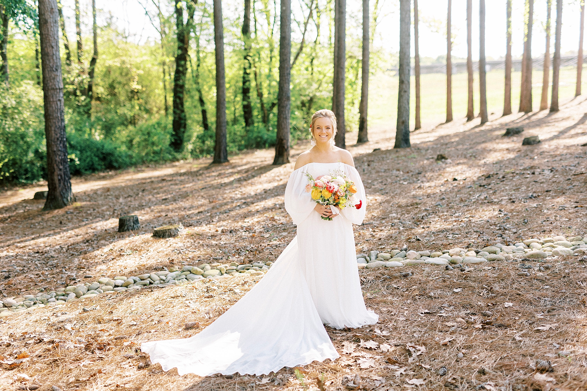 bride holds bouquet of red and white flowers 