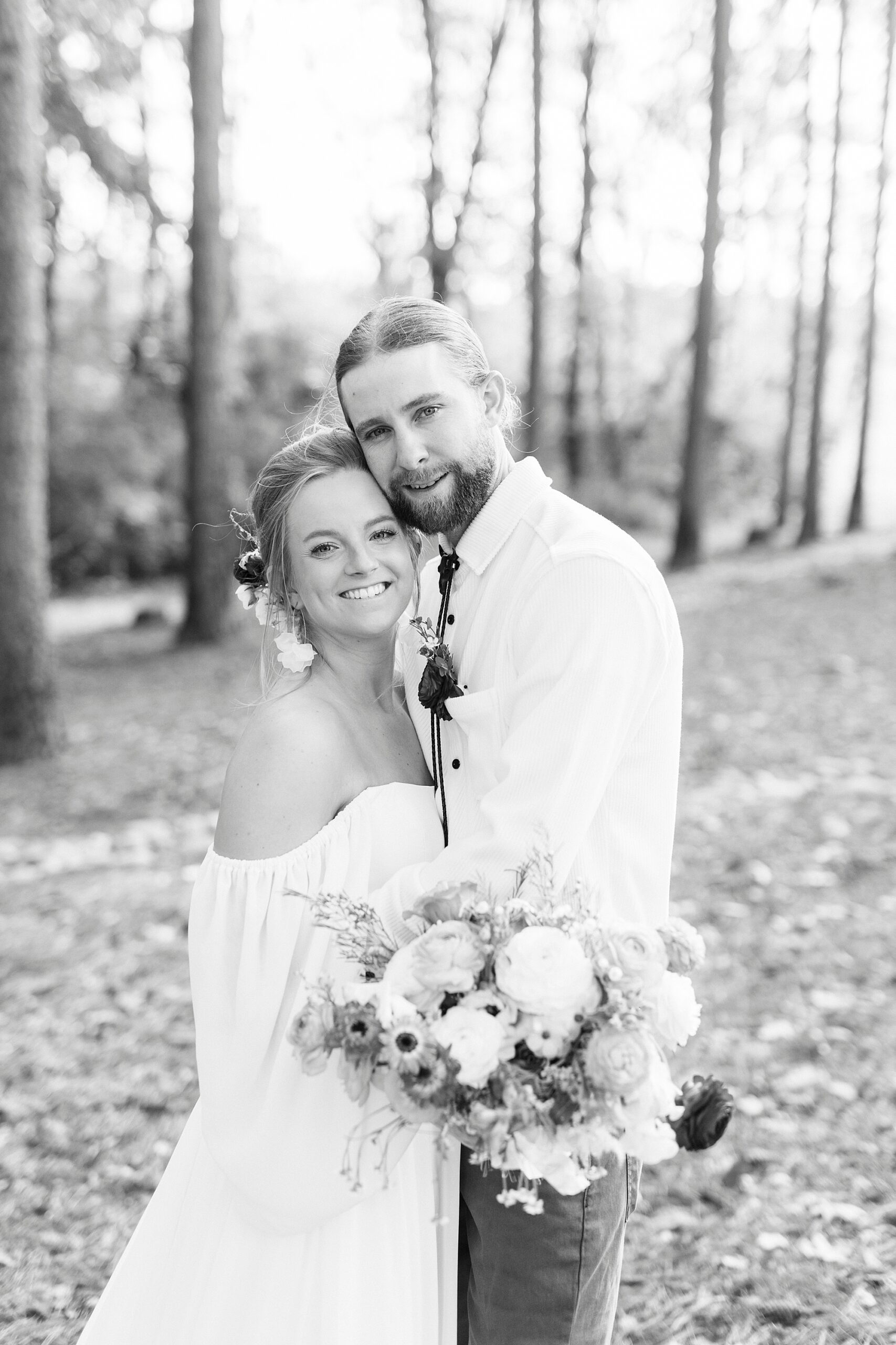 bride and groom hug leaning their heads together 