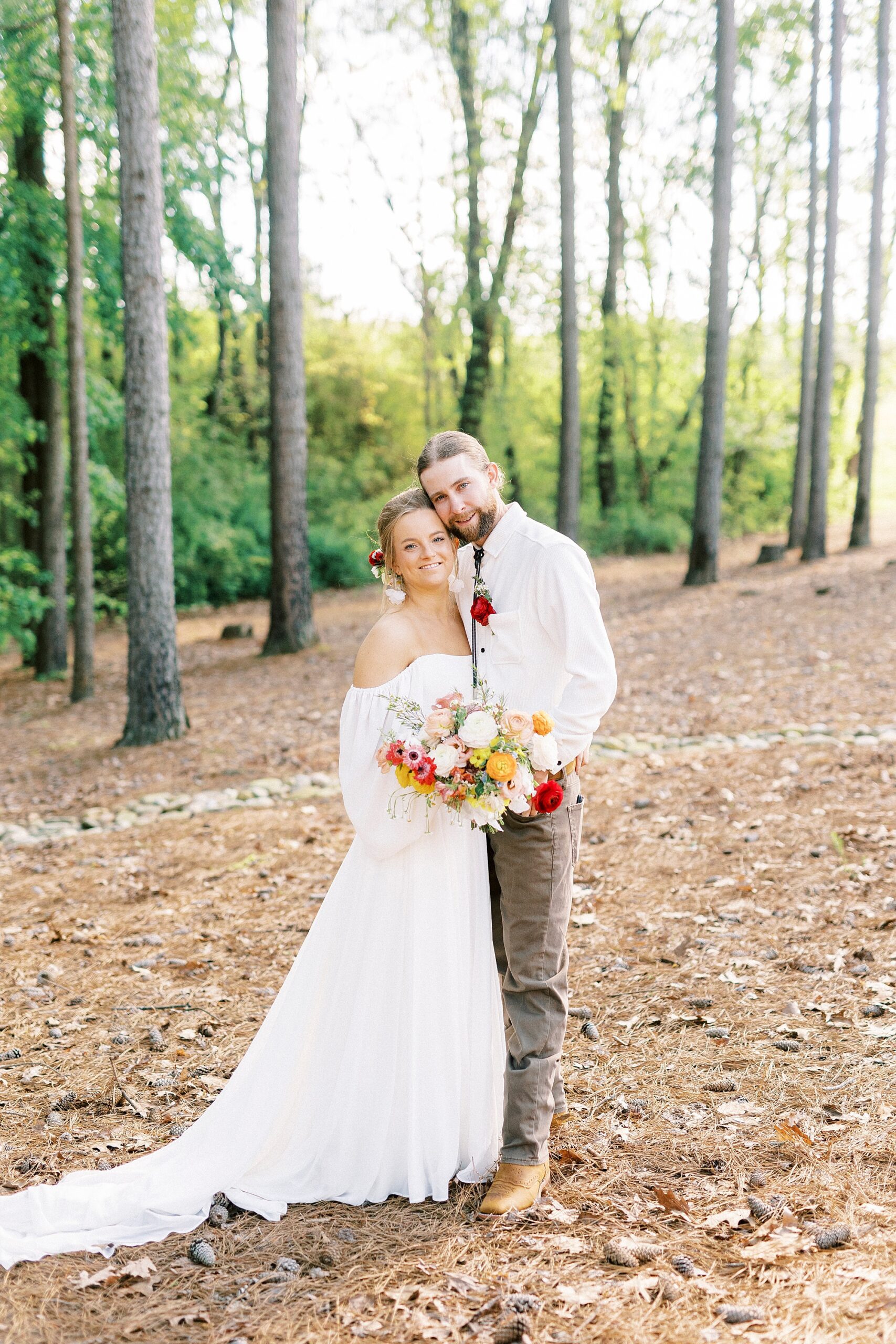 bride and groom hug on hill in Richfield NC
