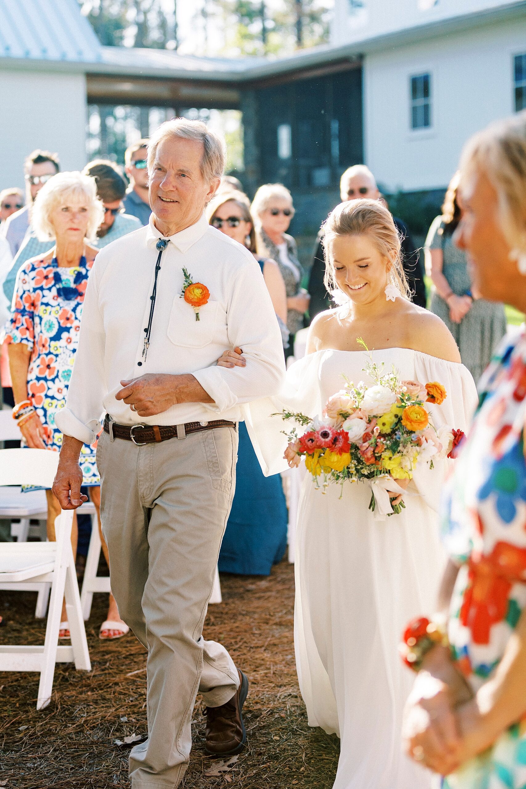 father walks bride down aisle for wedding ceremony on lawn of Richfield NC home