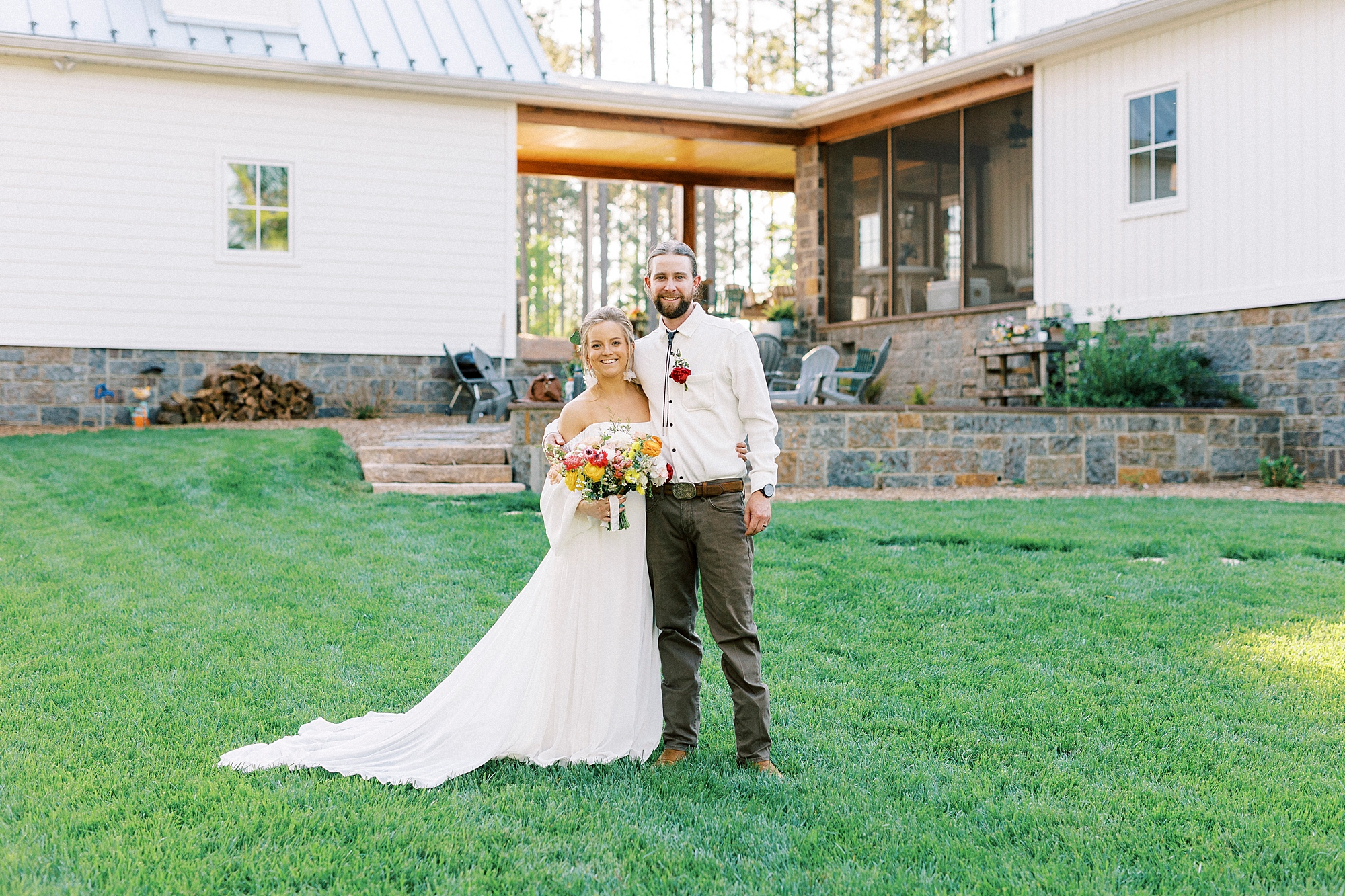 bride and groom hug on lawn in front of home in Richfield NC