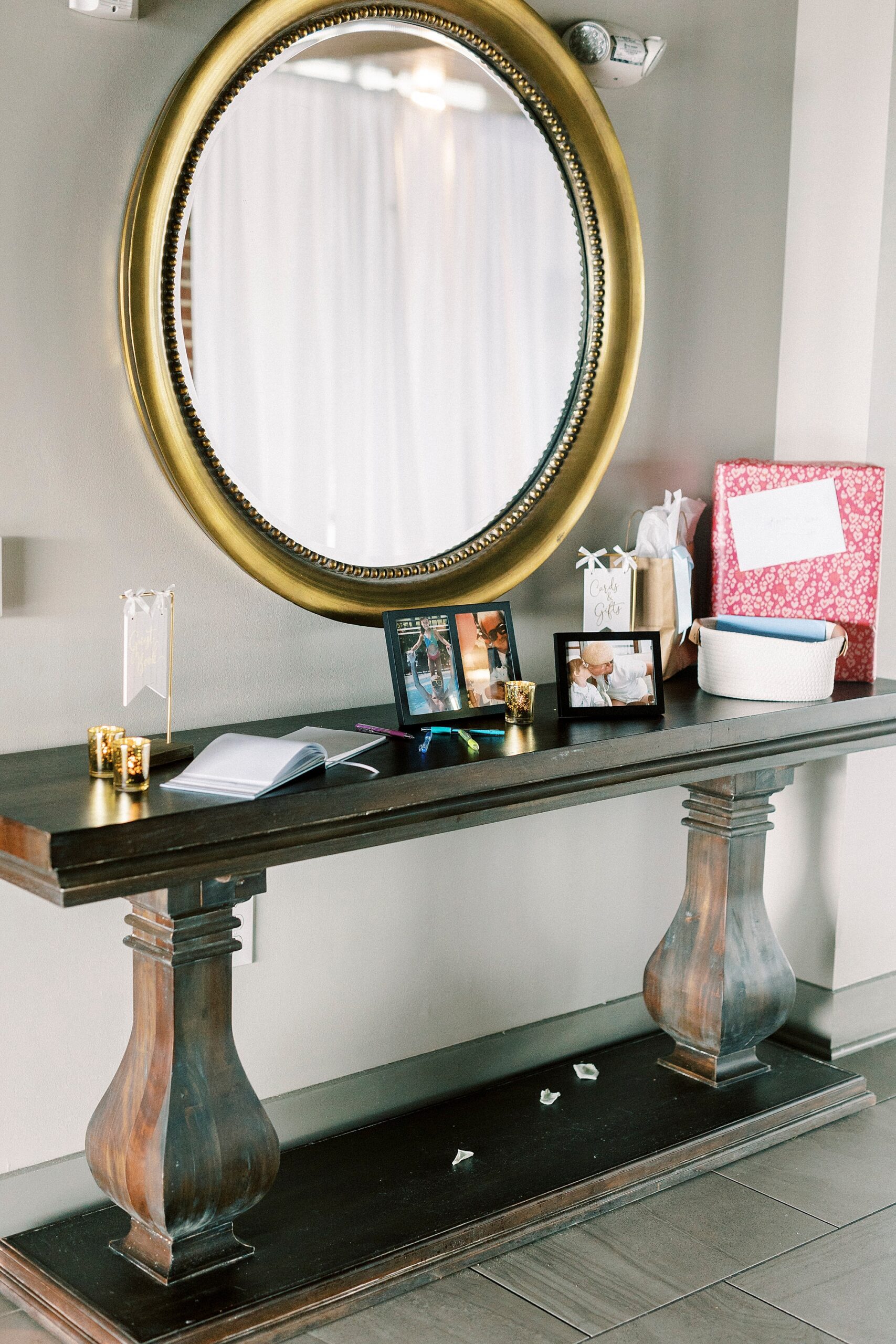 gift table with guest book under gold mirror
