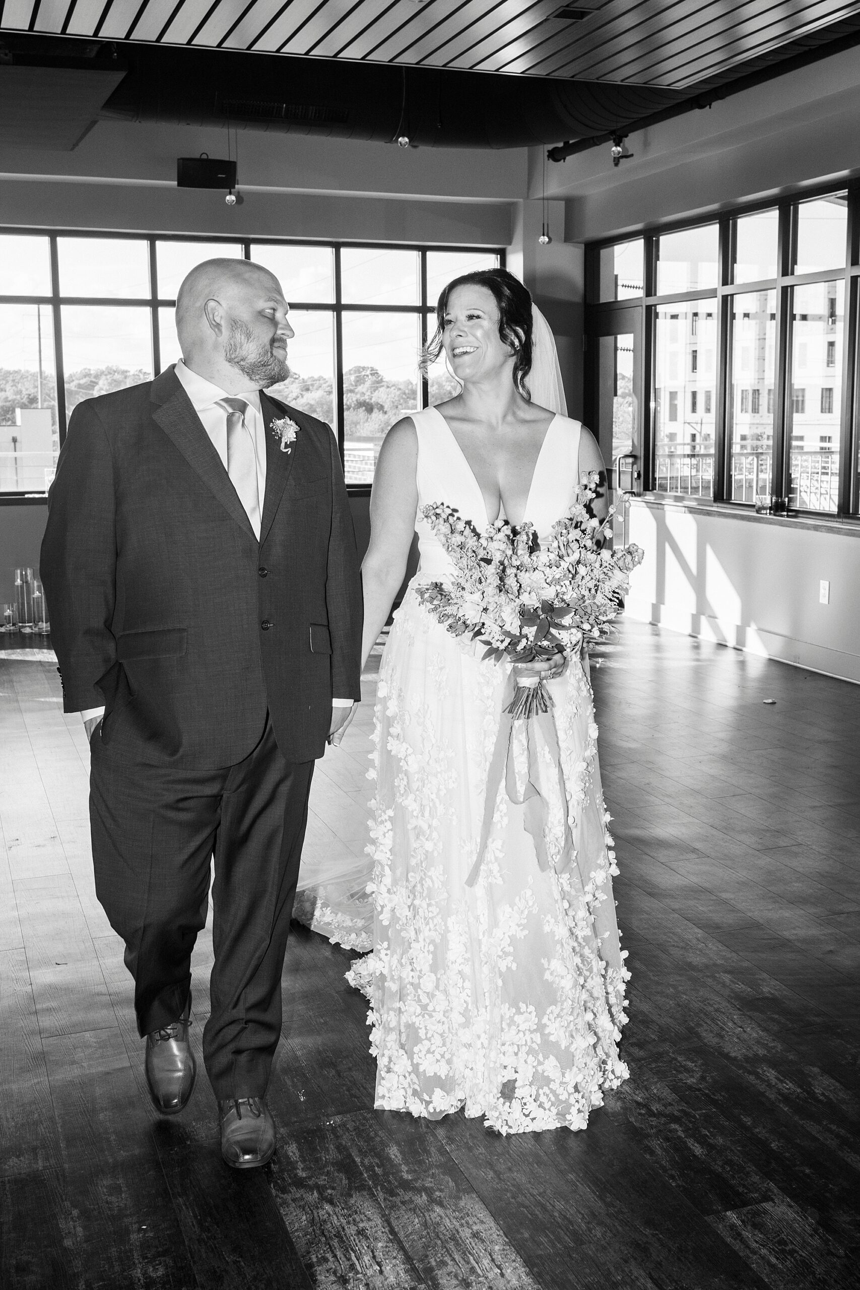 bride and groom hold hands walking through the Terrace at Cedar Hill