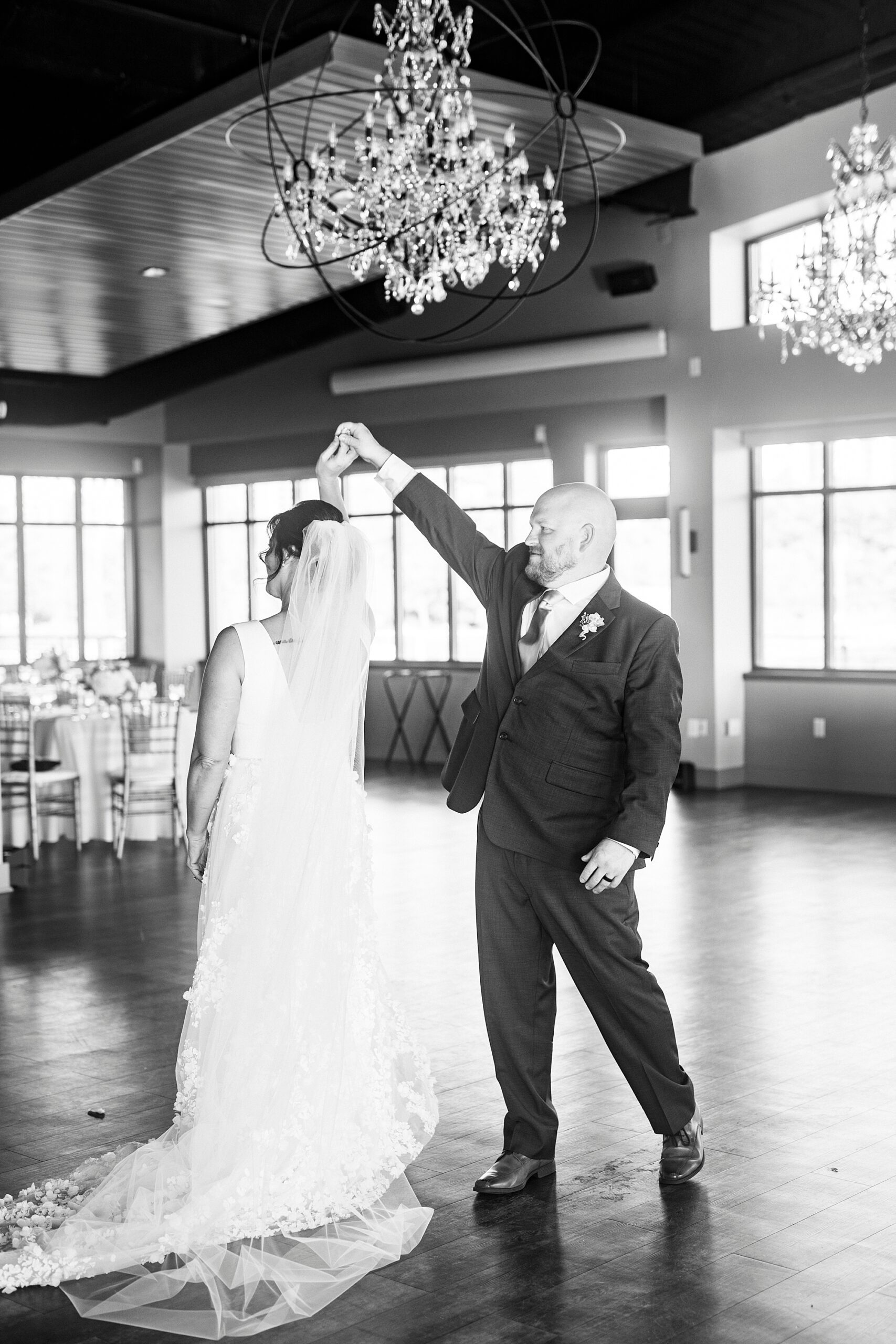 groom twirls bride inside the Terrace at Cedar Hill