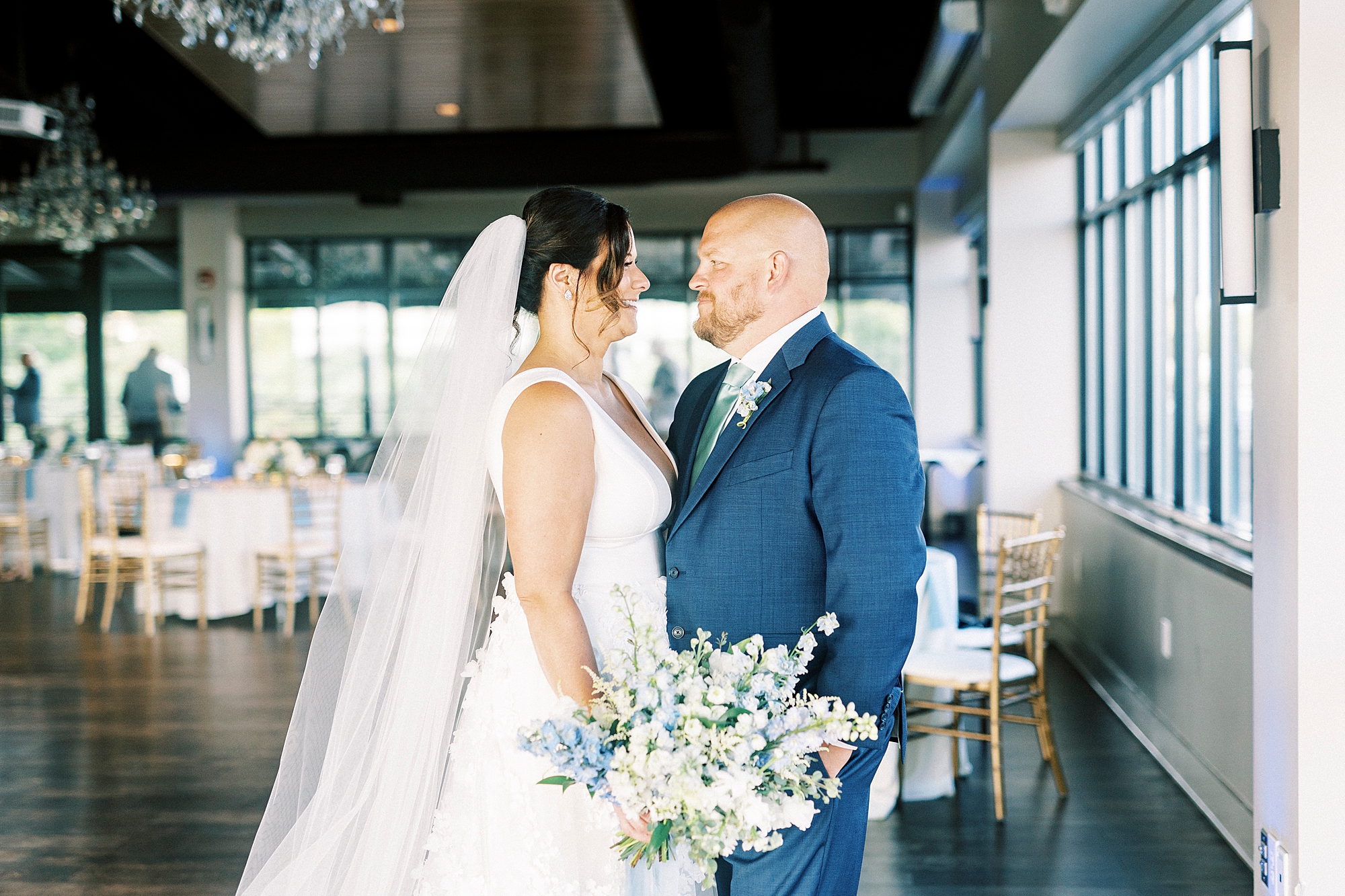 bride and groom stand smiling together inside the Terrace at Cedar Hill