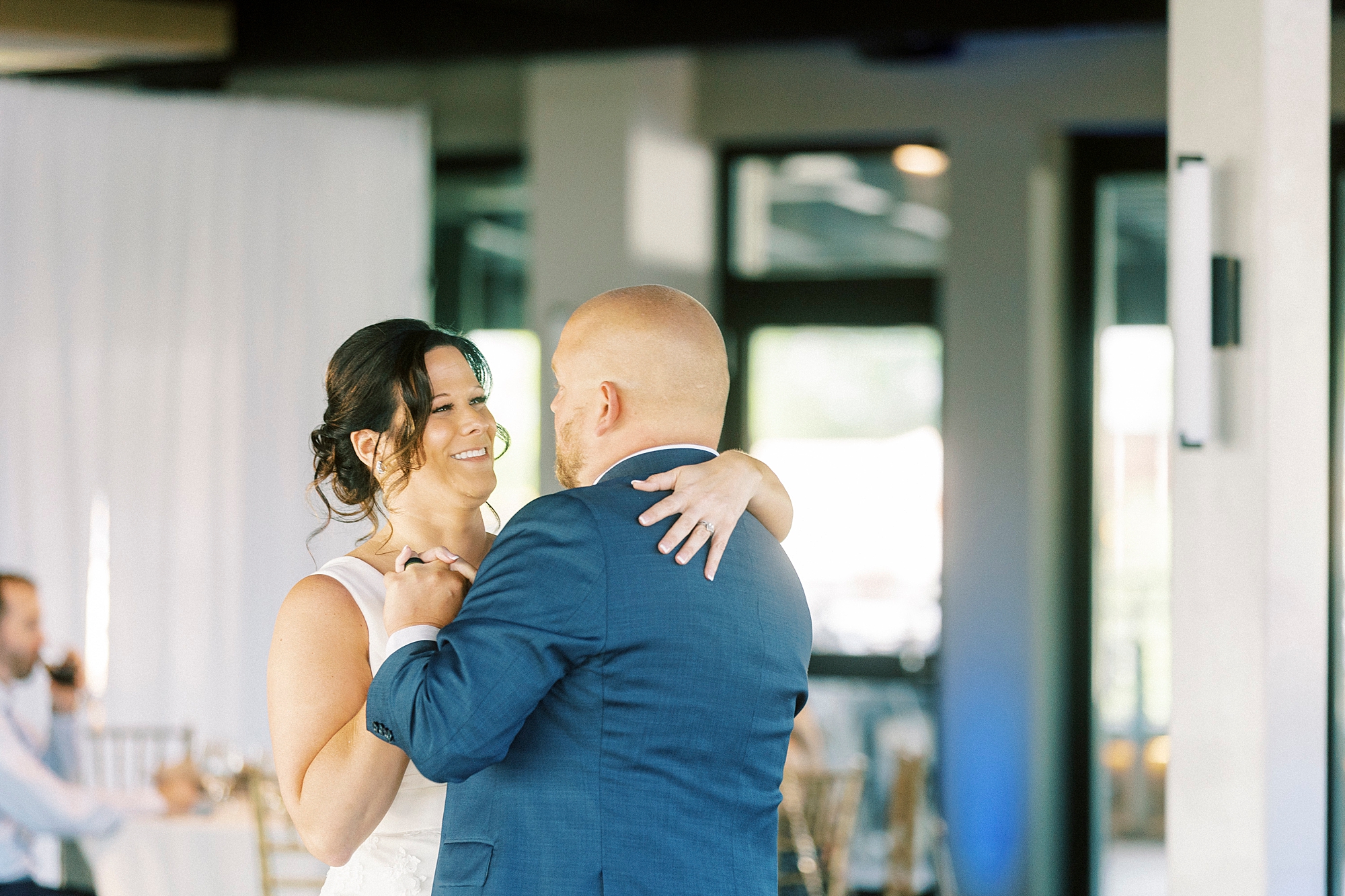 newlyweds grin during first dance in Charlotte NC