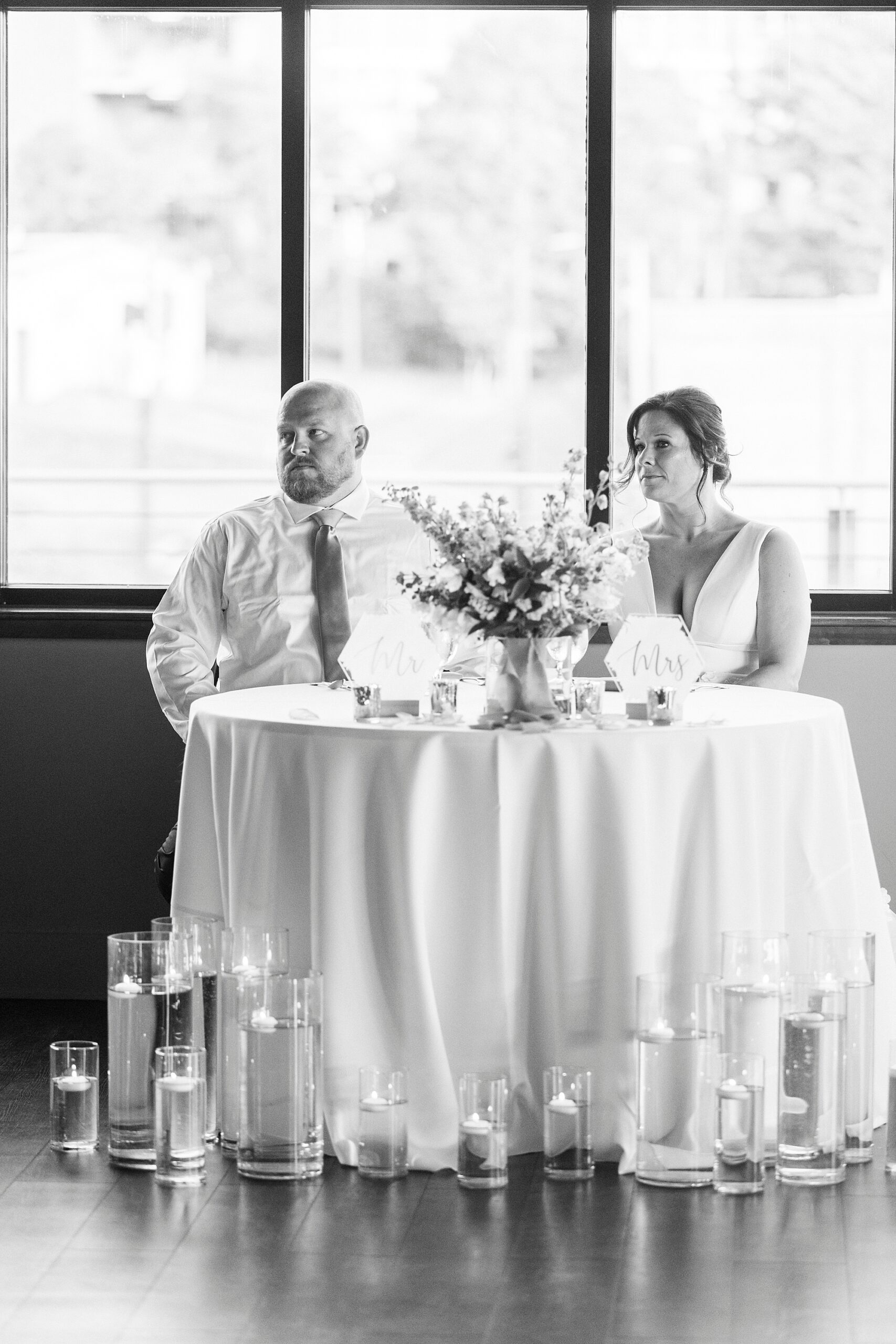 newlyweds listen to speeches during Charlotte wedding reception