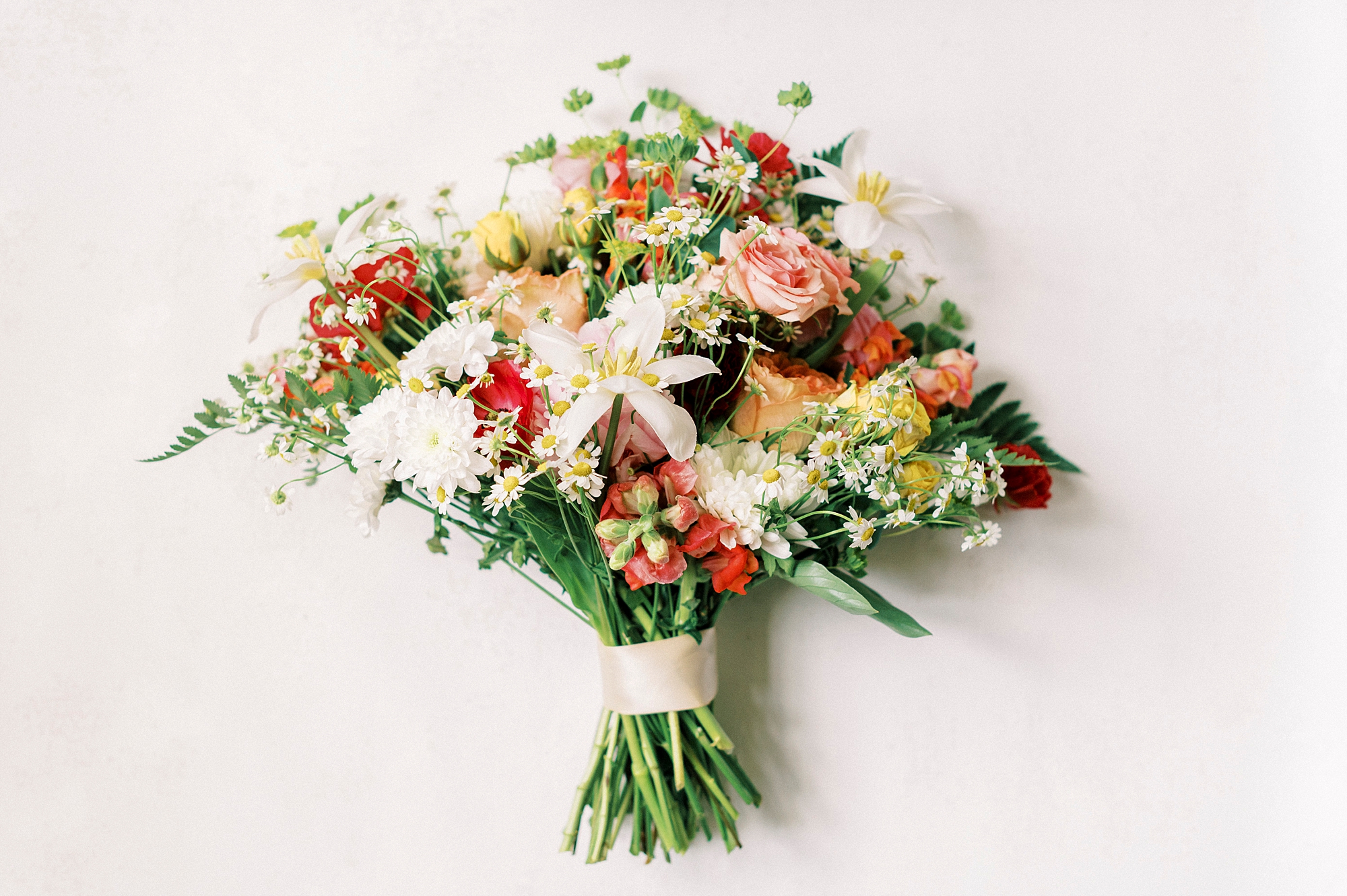 bride's bouquet for spring wedding with pink and red flowers