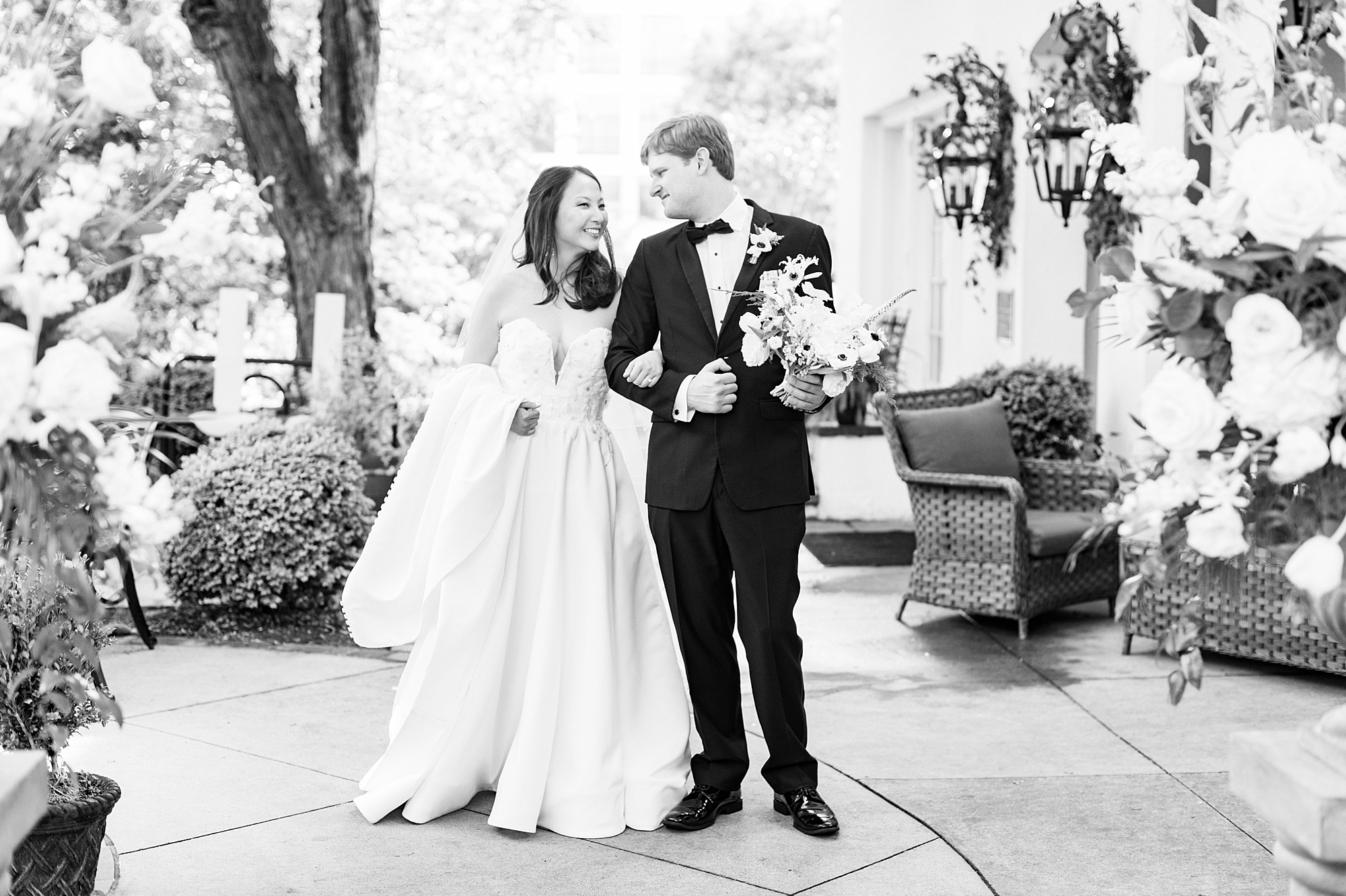 bride and groom smile at each other on patio at The Spring House