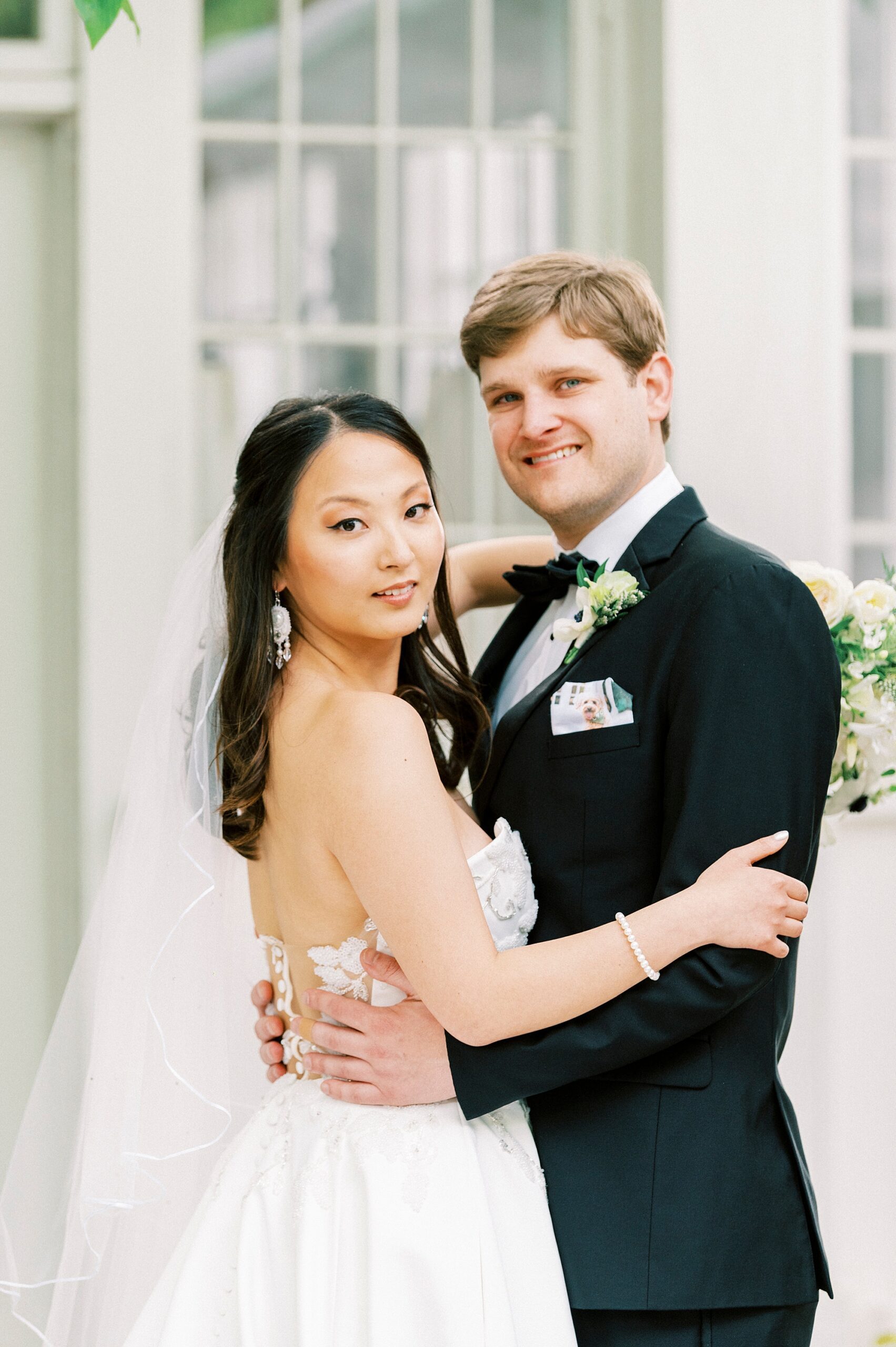 bride and groom hug on patio at The Spring House