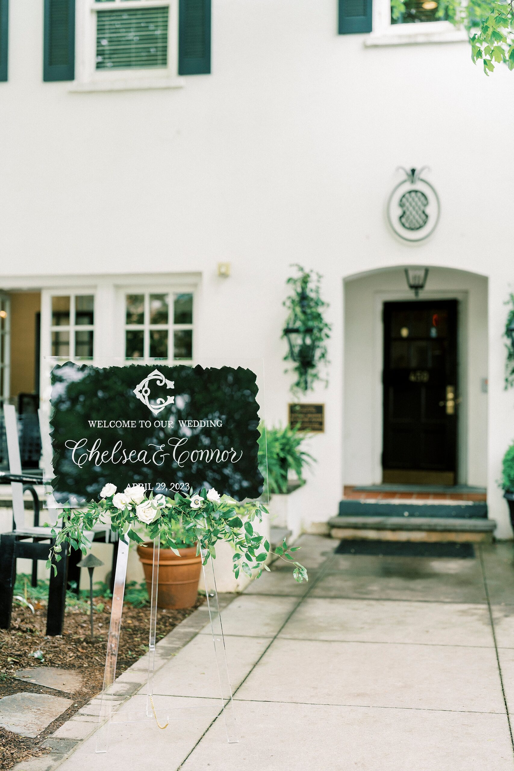 welcome sign with greenery and acrylic cover at The Spring House