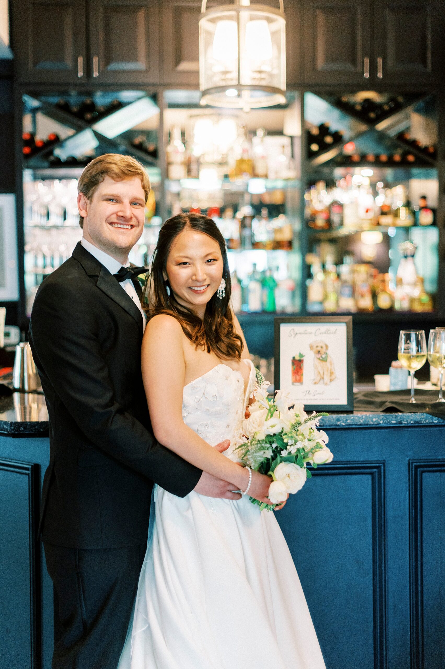 groom hugs bride outside bar inside The Spring House