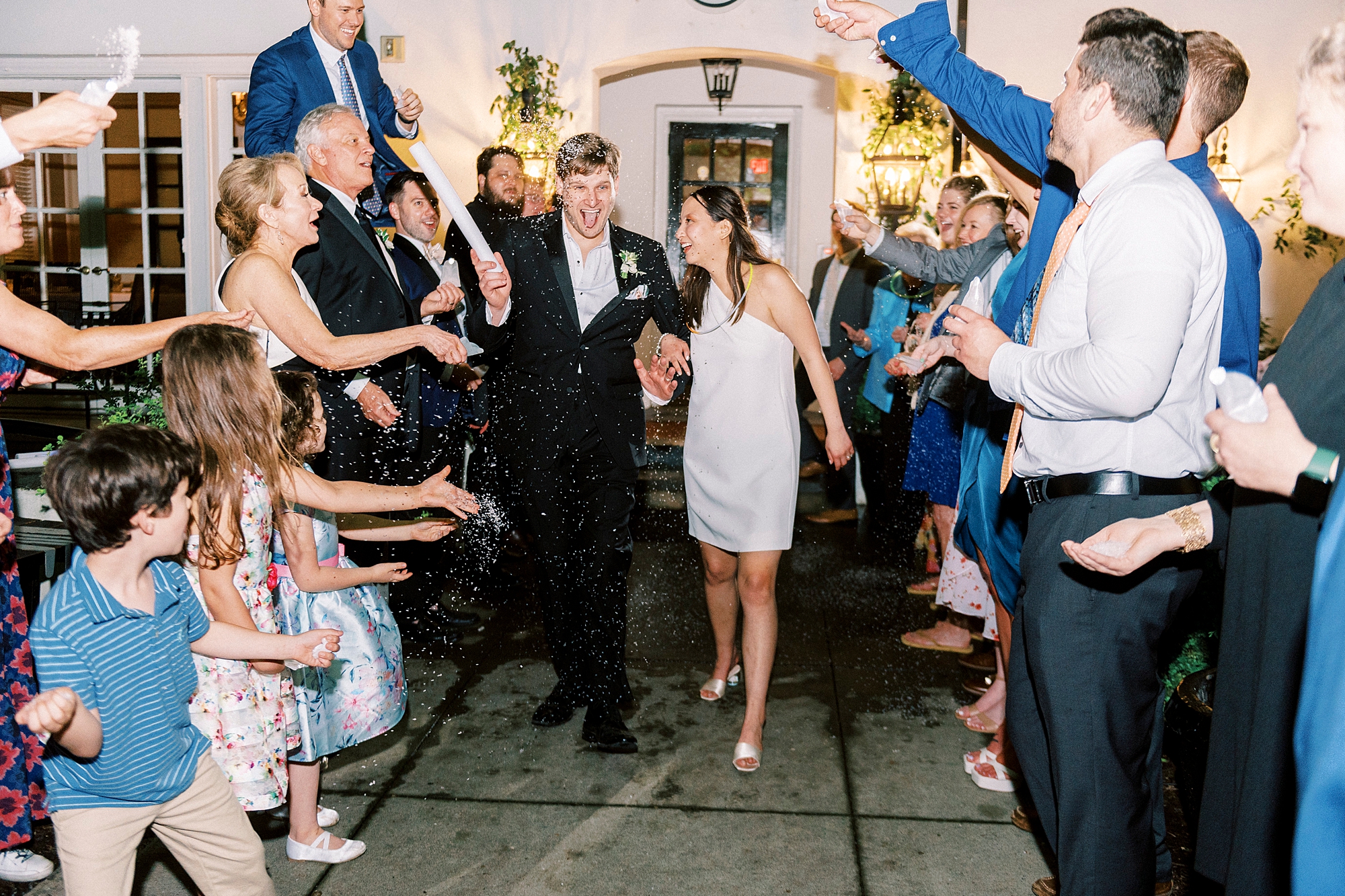 bride and groom leave wedding reception during sparkler exit