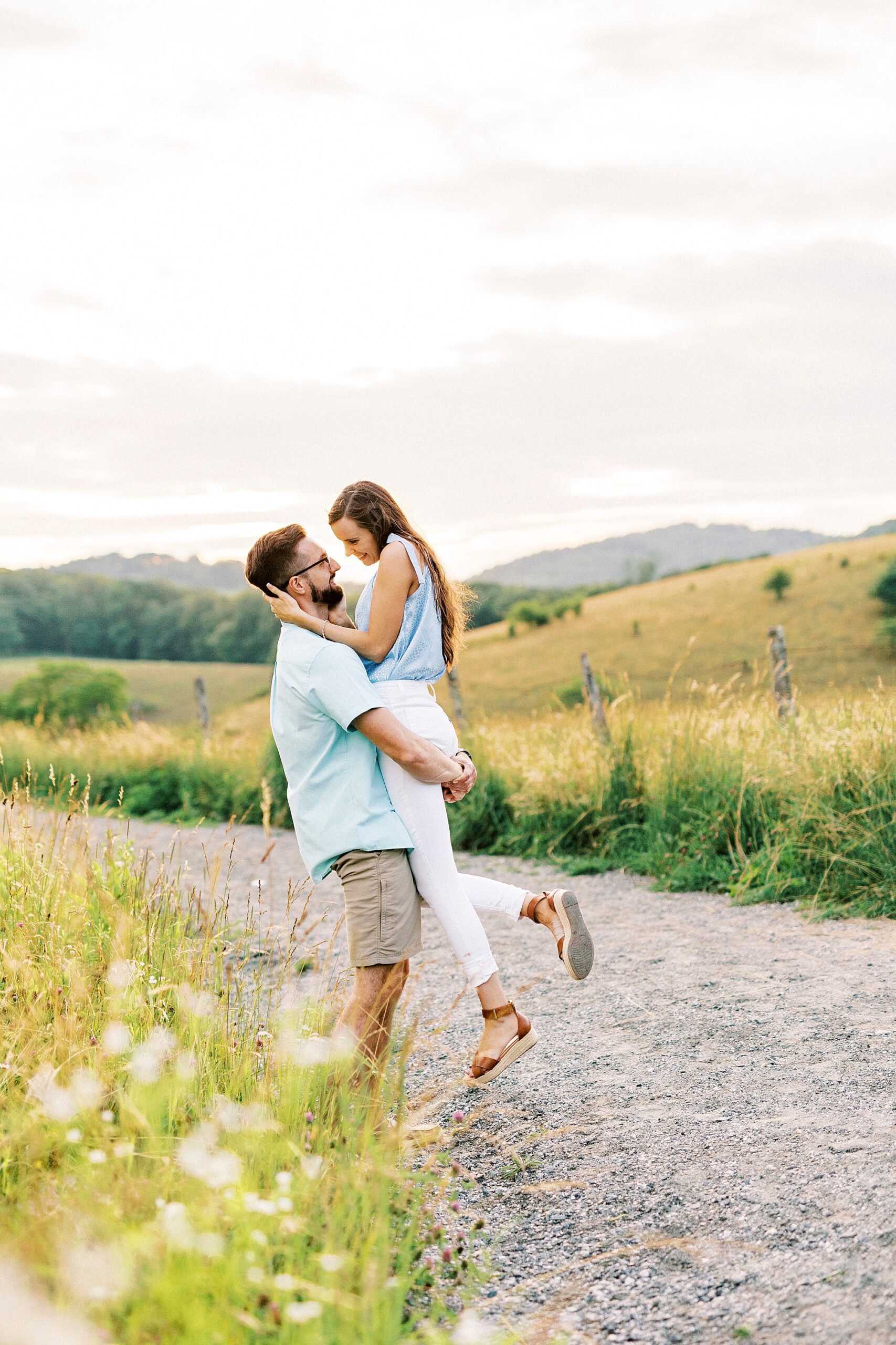 man lifts up woman looking up at her at Moses Cone Manor 